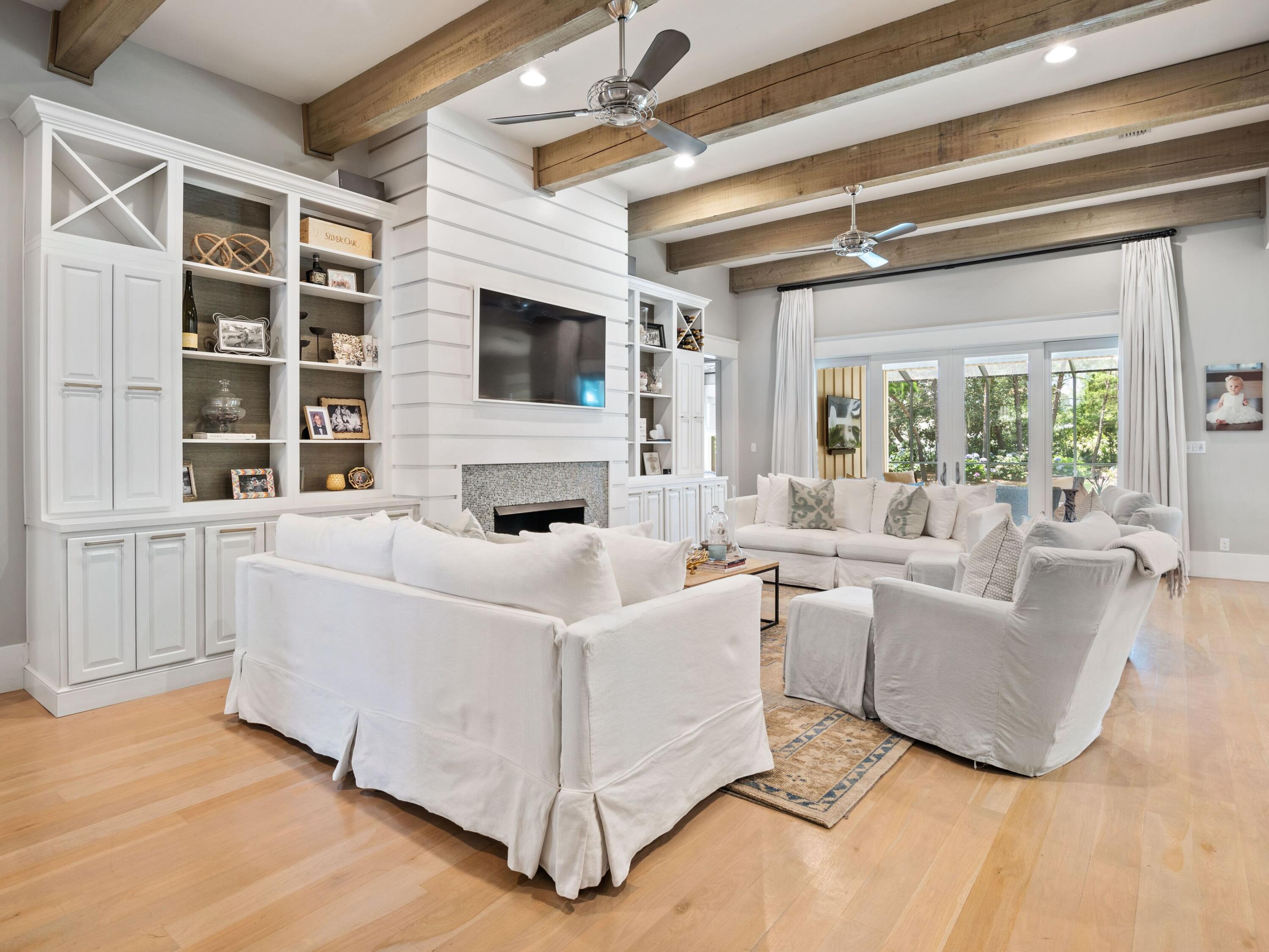 Quintessentially coastal and designed with palatial luxury around every corner, this masterfully built southern craftsman home provides an idyllic location for primary, or secondary living. Situated on an oversized corner lot and featuring four spacious bedrooms, the clean contemporary interior provides an immediate feeling of relaxation upon entry through the custom built front door. Hardwood and custom tile is showcased throughout the home, allowing light to bounce through the large portrait windows seen prominently through the property. Custom painted cabinetry and cabinet front doors adorn the appliances in the chef's kitchen, while shiplap accents and repurposed beams add additional touches of luxury desired by today's sophisticated home buyers.