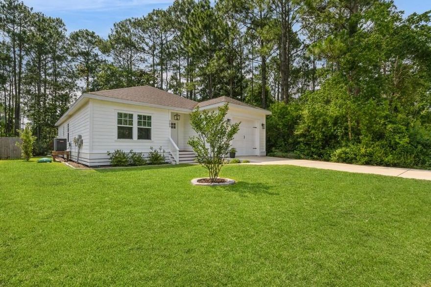 Beautifully maintained coastal home with an open, airy layout that exudes comfort and style. Everywhere you look, you'll find thoughtful custom finishes. Nine-foot ceilings and luxury vinyl plank flooring enhance the spacious feel. The kitchen features quartz countertops, a marble backsplash, custom cabinetry, and a large island. A floor-to-ceiling built-in with electric fireplace adds warmth and charm. Just three miles from the beach and one mile from the Bay's public boat launch. No HOA or monthly fees. Enjoy the freedom and elegance of beach living.