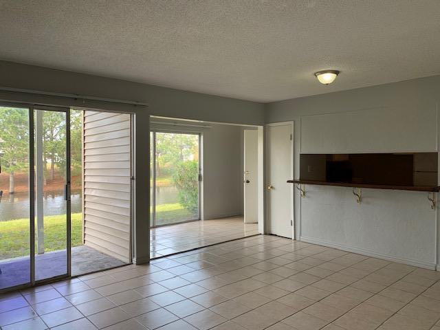 Easy access ground floor two bedroom, One bath condo ready for occupancy. Pretty Lake view. Tile flooring in the Living room. Washer/dryer hook up. Buyer to verify any and all dimensions.