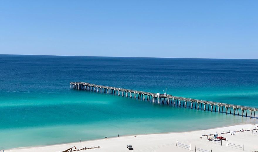 5-MINUTE WALK TO THE BEACH!  2B/2.5B well-kept, fully-furnished unit on the WEST side of PIER PARK for UNDER $300,000!  Complex amenities include 3 pools, tennis courts, clubhouse, workout room, and short-term/vacation rentals are allowed!  Entry is into the living area of this light & bright unit, which includes an open dining area, breakfast bar and kitchen.  The first floor is complete with pantry, enclosed laundry, storage and a half bath convenient for guests. Upstairs you'll find 2 bedrooms, 2 FULL baths and a covered deck for relaxing. Parking directly in front of the unit means easy loading/unloading, and no waiting for elevators. Storage for beach chairs and coolers adjacent to the front porch plus the covered back patio is perfect for your grill. Don't wait! See this one TODAY!