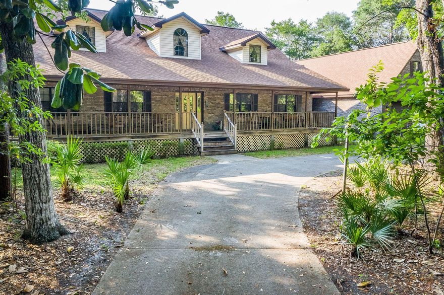 Wonderful waterfront estate located on pristine and protected Shirks Bayou with approximately 131' of waterfrontage. Flood Zone X. Beautiful Dock and boat lift with electric and water. This spacious home has 4 large Bedrooms and 2.5 Baths on the first floor and a large bonus/media/craft room above garage. Garage is oversized and can accommodate a small motor coach. inclusive of a work area and kitchenette. Lovely floor plan with a large living area and beautifully accented stone gas fireplace . Home features circular drive, expansive front porches, sunroom overlooking water, wood flooring, wet bar, large laundry room with additional pantry cabinets, new roof in March 2014 and 2 new AC's in July 2014. All measurements to be verified by buyer.
