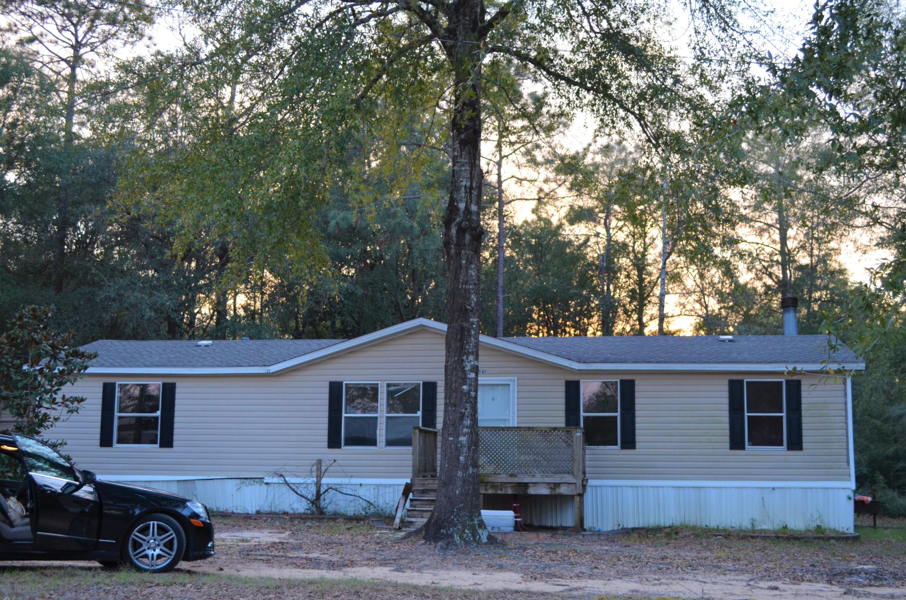 Large lot with a home for a very affordable price. Lot has beautiful trees and all the room you need in a great location close to Hwy. 90. It would make a great rental if you are in the market for an investment. 3 bedrooms, 2 bathrooms with all major systems working, just needs a little cosmetic touch up. Home is empty, no utilities on currently. Easy show.
