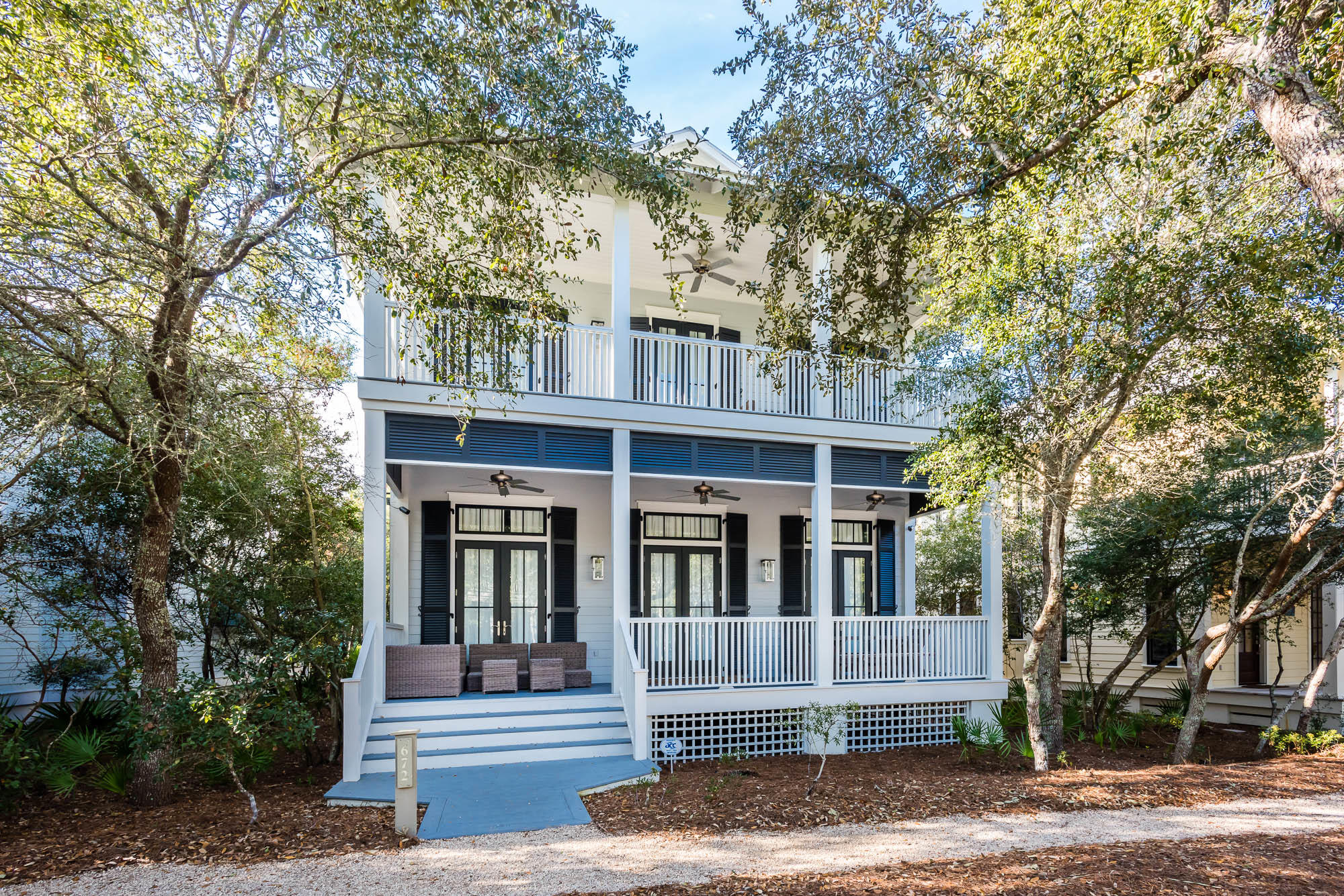 Located in the heart of phase I, this WaterColor beach house welcomes you home with its expansive front porch meant for enjoying the Florida outdoors. The double door entry receives guests to the homes expansive, open concept great room featuring beautiful hardwood floors and wainscoting throughout. Natural light floods the large living area that is equipped with crisp white, upscale coastal dcor and a painted brick fireplace to warm up Florida's coolest evenings. The home's large dining area offers a solid wood table with seating for eight and opens up to the expansive kitchen featuring a big breakfast bar with marble countertops and additional seating for six, contemporary pendant lights, Thermador dishwasher and fridge, no slam cabinets and drawers, an apron sink, and a large center is