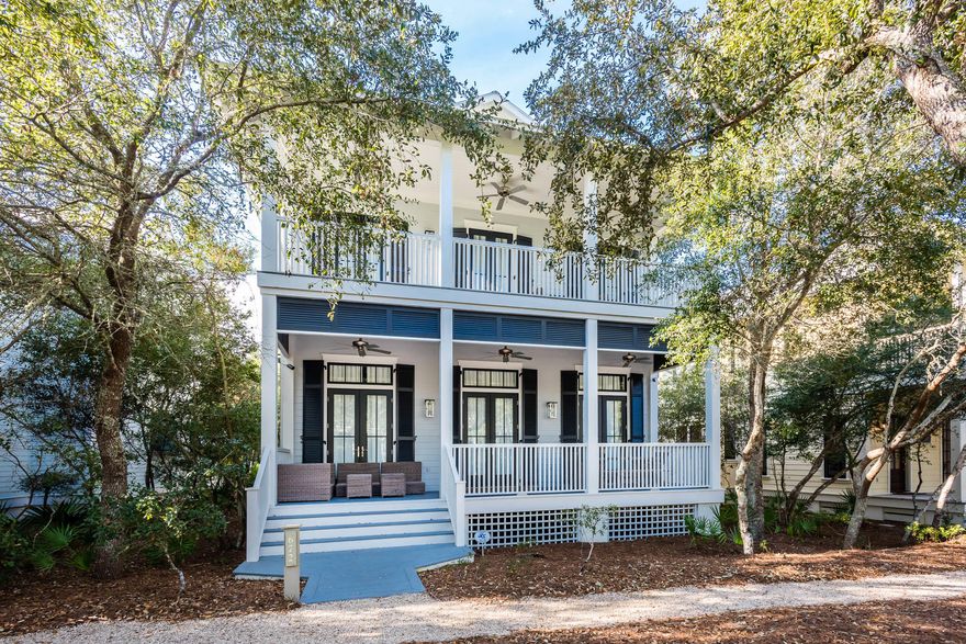 Located in the heart of phase I, this WaterColor beach house welcomes you home with its expansive front porch meant for enjoying the Florida outdoors. The double door entry receives guests to the homes expansive, open concept great room featuring beautiful hardwood floors and wainscoting throughout. Natural light floods the large living area that is equipped with crisp white, upscale coastal dcor and a painted brick fireplace to warm up Florida's coolest evenings. The home's large dining area offers a solid wood table with seating for eight and opens up to the expansive kitchen featuring a big breakfast bar with marble countertops and additional seating for six, contemporary pendant lights, Thermador dishwasher and fridge, no slam cabinets and drawers, an apron sink, and a large center is