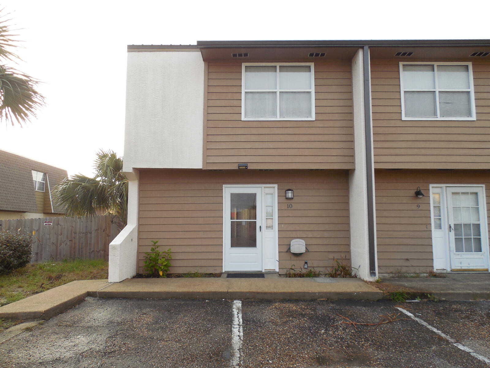 Location! Location! Location! 2 bedroom 2 full bathrooms on Okaloosa Island. Walking distance to the beach, restaurants and night life. With a few minor repairs and some updating this could be your own little piece of paradise. Both bedrooms are upstairs with a full bathroom and laundry room between them. Small balcony off of master bedroom. Downstairs is the kitchen, living room and full bathroom. This is an end unit and has 15 foot of property on the south side and a small backyard with deck. Brand new roof and gutters installed just a few months ago, all of the wood on the outside has been repaired, sealed and painted. HOA is in the process of painting all of the front doors. Very low HOA covers building insurance!