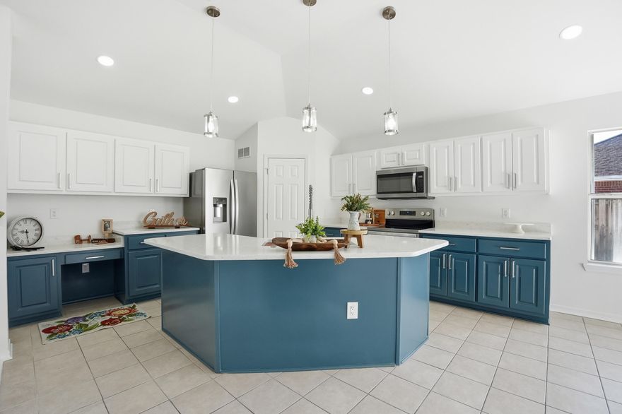 This beautifully remodeled four-bedroom home offers a thoughtfully designed split floor plan that balances comfort, functionality, and space for entertaining. The open-concept layout seamlessly connects the family room, dining area, and kitchen, while a decorative half wall with classic columns adds architectural character and subtle separation.The inviting family room is centered around a cozy fireplace, creating a warm gathering space. The kitchen offers a breakfast bar, corner walk-in pantry, and a built-in desk/computer station, providing both style and everyday convenience.The generously sized primary suite features sliding glass doors leading to the covered back porch, offering a private retreat. The ensuite bathroom includes a relaxing garden tub, separate shower, dual vanities, and a walk-in closet. Three additional bedrooms and a guest bath are located on the opposite side of the home, ensuring privacy for family members or guests.