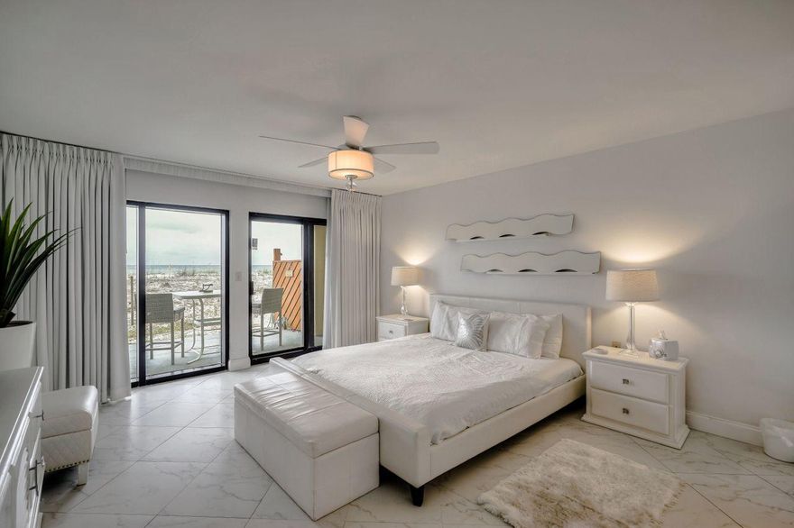 Welcome to your little slice of heaven along the beautiful Emerald Coast! This spacious 1st floor unit has gorgeous, unobstructed views of the crystal white sand beaches and emerald green waters of the Gulf of Mexico. Drive right up to your front door! No waiting in line at an elevator nor steps to tackle to take you to your unit. Slip through your master bedroom or living area sliding glass doors onto your 450 sq. ft. patio to enjoy a cocktail at sunset with friends and family with easy access to the dedicated beach walkover. The kitchen comes fully equipped with stainless steel appliances including refrigerator w/ ice maker, garbage disposal, dishwasher, self-cleaning oven, and microwave with a separate, adjacent laundry room as an added bonus with full-sized washer and dryer. The open living space includes a table for 6, small wine refrigerator, reclining leather sofa, custom 10x12 area rug, and a 50" television all creating a great oasis to relax at the end of a long beach day. The master suite is a fully-remodeled DREAM with king size platform bed, 36" television and a wall mounted heat/no heat sand designed fireplace. Floor to ceiling sheer and blackout window treatments provide incredible natural sunlight throughout the day while also providing a dark and cozy atmosphere for a good night's rest. The master bathroom comes equipped with a custom sliding barn door and a pocket door separating the updated vanity/closet space from the soaker tub/shower area for added privacy. The 2nd bedroom includes a queen size bed and an extra-long twin size bed with trundle and access to the 2nd guest bathroom. Investors have the easy option to rent this unit as a 1BR or 2BR unit. Surf Dweller amenities include a heated pool, fitness center, lighted tennis/pickle board courts, beach chair service w/ discounted fee, barbecue grilling area, parking garage and security cameras. Come check out this incredible unit today!