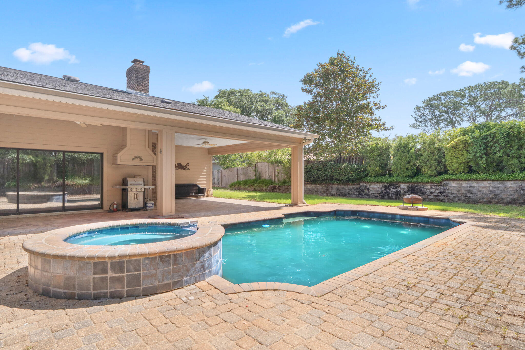 Located in the heart of the sought-after Poquito Bayou area in Shalimar, FL - this spacious 5 bedroom, 5 bathroom home in the Longwood Pines subdivision is a one-of-a-kind property - with no HOA! The perfect location for anyone that commutes to any of the local area military bases - just 3.2 miles from the West gate of Eglin Air Force Base! Inside, the home boasts generous living spaces, including a versatile great room with its own ensuite bathroom - ideal for use as a private den, office, or a fully equipped mother-in-law suite. The open concept main living area features the kitchen with granite countertops and a breakfast bar and blends into the living room that showcases a floor to ceiling brick fireplace and 3 sets of slider doors that all slide completely into the wall to open the backyard patio space - making the most epic entertainment spot for those good weather nights - showcasing the covered, paver patio with grilling area and the in-ground spillover pool and spa that is the main attraction for this backyard oasis! The primary suite features an oversized walk-in closet, a spa-like ensuite with a double vanity, walk-in tiled shower, and a separate tub. The 4 additional bedrooms - one with its own ensuite bathroom, and two that share a Jack-and-Jill bathroom - are just down the hall. Schedule your showing today and make this unique Shalimar yours today!