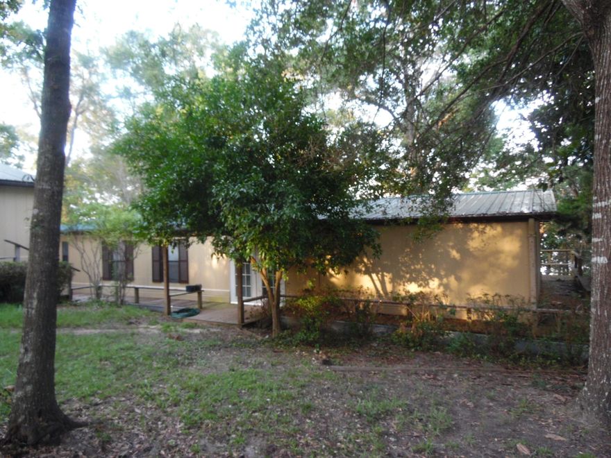 Waterfront double wide manufactured home on 2 lots and detached 2 car garage for $125K. A 1512 sq. ft manufactured home on appx. 1 acre waterfront lot on Kings Lake. The manufactured home has 3 bedrooms, 2 baths, new appliances, remodeled master bath with large ceramic shower and a detached 2 car garage,new a/c, wrap around porch, beautiful magnolia trees, and dock. Seller giving $3K floor covering allowance at closing--CLICK ON ''MORE Tab''