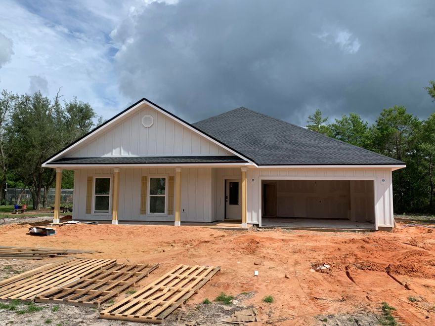 Discover this fantastic new construction home situated on a half acre lot at the end of a cul-de-sac inside one of Freeport's best kept secrets, Indian Bay! The wide, covered front porch offers a warm Southern welcome to a beautifully laid out, split bedroom floor plan featuring an open-concept kitchen, living, dining area at its heart. Three spacious bedrooms, a full bath with double sink vanity, and a dedicated laundry room occupy one wing of the home, while the primary bedroom and en suite bath with tiled shower, garden tub, double sink vanity, and massive walk in closet sit on the opposite side of the living space. Find a conveniently placed powder bath in the hall leading to and from the 2-car garage. Home will be finished with quartz counters and shaker-style cabinets in kitchen and full baths, steel appliances (range, dishwasher, vent hood), and abundant crown molding. Enjoy views of the oversized backyard from the rear lanai. Indian Bay offers residents unique and valuable access to Choctawhatchee Bay from its shared community dock! The neighborhood's location halfway between Niceville and the city of Freeport makes commuting a breeze.