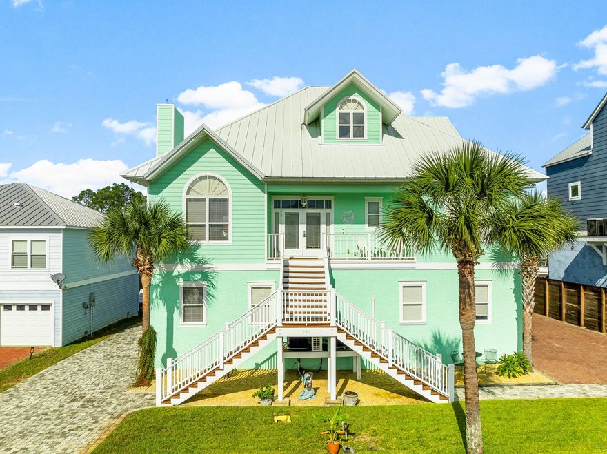 Deep water executive home with significant upgrades and a 10,000 pound boat lift accommodating a 37 foot boat with 4+ foot draw with easy access to the Bay, Shell Island, and the Gulf of Mexico PLUS there is a commercial-grade seawall, covered boathouse with lift. There is additional room to install another lift for another boat or jet ski if you need it. Superior grade deck material for easy maintenance and longevity. This magnificent home sits on a double-lot in a private, gated community, this 4BR/3BA, 3,241sqft property, offers an exceptional investment opportunity and is perfect for a primary residence or second home (vacation rentals not allowed). Upgraded to satisfy discerning tastes, the property features an entertainment-ready floorplan, 1st floor primary bedroom, separate lock-out guest-suite, outdoor kitchen with grill, 2 new HVACs (2021), and an open concept kitchen with new appliances (2021). Some of the many upgrades include: hardwood and tiled floors, vaulted and trayed ceilings with recessed lighting, 10 foot ceilings, transom windows, pocket doors, designer colors, large baseboard molding and built in sound system. The first floor has a huge game room with billiards or entertainment on one end and room for relaxing and watching TV on the other. There is also a large guest room with private bath with granite countertop. The 2nd floor gourmet kitchen has custom cabinets, granite countertops and stainless appliances. The vaulted great room has a beautiful fireplace with built-in shelves and cabinets along with tongue and groove paneling. The huge sunroom is bright and airy and opens onto a 10'X 38' screened porch. There are 2 more bedrooms and a full bath with granite countertops on the second floor. The 3rd floor is the master suite with a huge bathroom with jacuzzi tub and separate shower. Large walk-in closet and screened balcony complete this beautiful home. A home located on a double lot, deep water, and Gulf access at this price point is hard to find. This home is great for the growing family or entertaining and is close to shopping, restaurants, entertainment, and white sandy beaches and is the only home in this development that sits on a double lot. Call for your private showing today.