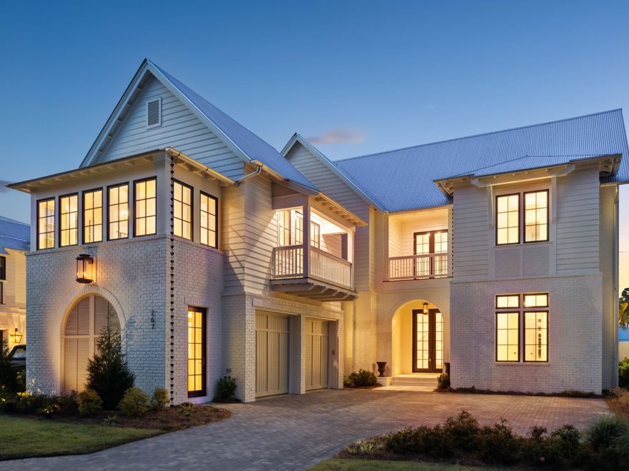 Tucked away in the highly sought-after bayfront community of Churchill Oaks, 267 Tyler Drive is a newly built lakefront masterpiece that seamlessly blends coastal sophistication with relaxed luxury. Thoughtfully designed and impeccably finished, this five-bedroom estate--with dual primary suites and a private carriage house--was created to enhance everyday living while celebrating the natural beauty of its lakefront setting. The home's timeless exterior pairs painted white brick with classic coastal lap siding, wood accents, and arched architectural details. The carriage house is positioned above the detached two-car garage, offering a private retreat separate from the main home. Lush landscaping frames the property, leading to an inviting front porch and grand entry.

Inside, the interiors are a study in light and flow. White oak plank wood flooring runs throughout, complementing the soaring ceilings and expansive windows that fill the home with natural light. The open-concept layout centers around a Venetian plaster fireplace, creating a warm and elegant focal point in the main living area. Floor-to-ceiling glass doors provide a seamless transition to the lakefront courtyard, while a screened-in balcony offers serene views of the lake and walking pathideal for morning coffee or evening wine.

The chef's kitchen is equally impressive, designed for both beauty and function. Taj Mahal quartzite countertops elevate the space, while custom cabinetry, a spacious waterfall island, an integrated bar area with floating shelves, and a designer tile backsplash complete the elegant aesthetic. Thoughtful touches like a dedicated wine cooler, bar sink, and adjacent dining space with statement lighting enhance the home's entertaining potential.

The primary suite on the main floor is a true retreat, featuring a spa-inspired bathroom with marble tile, a deep soaking tub framed by oversized windows, and an expansive walk-in shower with dual shower heads and a built-in bench. A custom walk-in closet is outfitted with dual dressing areas, drawer towers, and a vanity station.

Upstairs, a second primary suite offers privacy and breathtaking lake views, while additional guest suites feature en suite baths and designer finishes. A private elevator ensures effortless access to all levels.

Step outside into your private courtyard oasis, where a tranquil pool with cascading water features creates an intimate, resort-like ambiance. Designed for year-round enjoyment, this space offers the perfect balance of privacy and luxury.

The separate carriage house is a private retreat, featuring a living space, bedroom, bathroom, and a private balconyideal for guests, extended family, or an au pair suite.

Churchill Oaks is an amenity-rich community spanning 40 acres along Hogtown Bayou. Residents enjoy exclusive access to a deep-water marina with 36 private slips, a bayfront clubhouse with breathtaking views, resort-style pools, and a state-of-the-art fitness center. Meandering pathways lead to the water, offering endless opportunities for paddleboarding, boating, fishing, or simply enjoying the sunset over the bayou.

267 Tyler Drive is more than a homeit's a refined lakeside sanctuary in one of 30A's most desirable waterfront enclaves. Whether you're seeking a full-time residence or a luxury coastal retreat, this property delivers an extraordinary lifestyle with unmatched design, craftsmanship, and attention to detail.