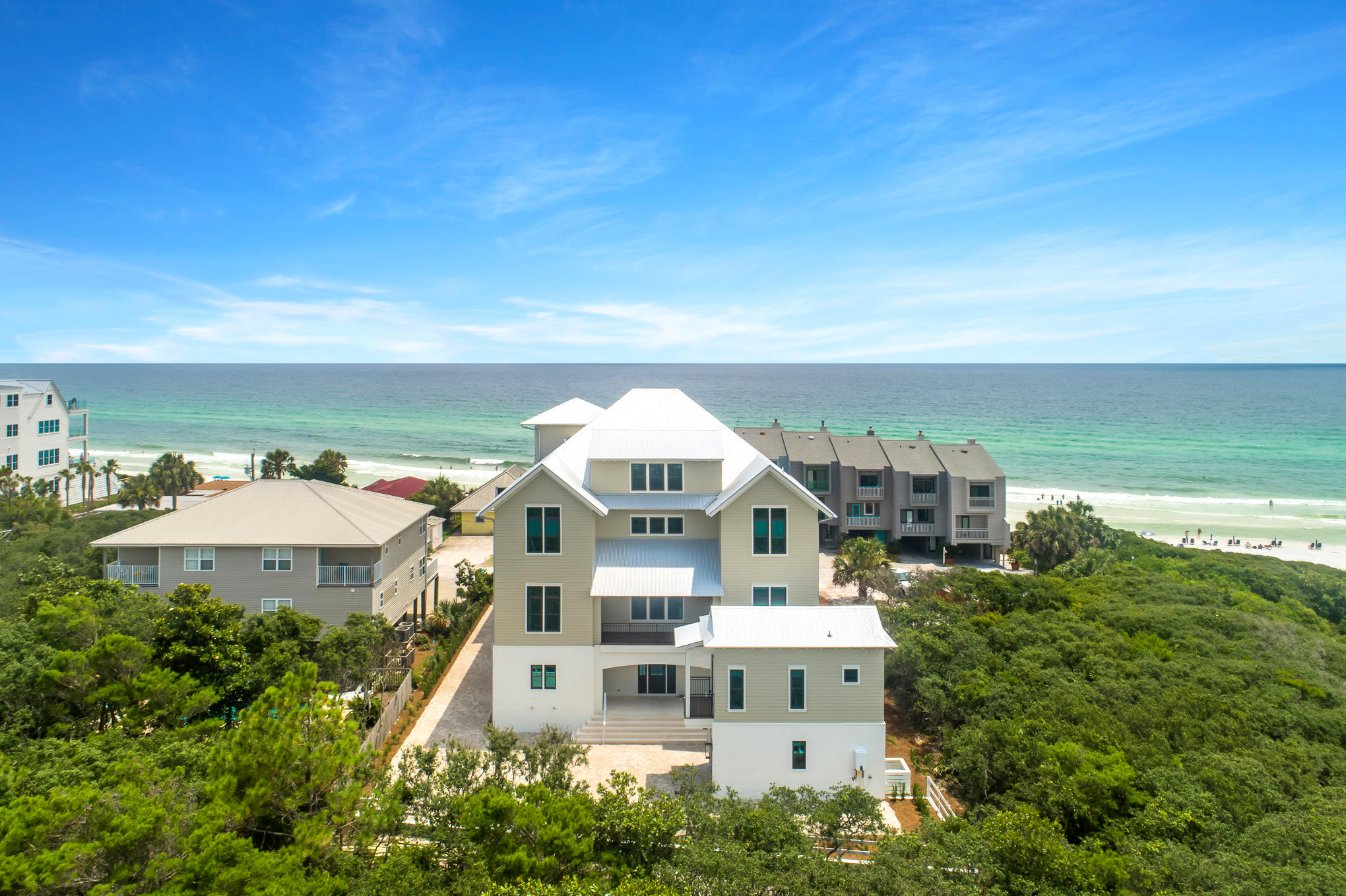 Sweeping forever views of the Gulf of Mexico paired with astonishing architecture characterize this exquisite Seagrove Beach estate. Positioned adjacent to the sugar white sands, 40 Hinton-Bishop Drive offers private beach access within steps of the front door, a large resort style private pool, a detached carriage house and views from every level. The well-thought-through floor plan offers over 7000 square feet, 10 bedrooms, 10 full bathrooms, 3 half bathrooms and over 4000 square feet of porches. Features of the home include reclaimed beams in the great room, reclaimed oak flooring throughout the upper levels, coral shell stone floors on the ground floor, pine wood walls throughout the home, brick accents, a gas fireplace, a 4 stop elevator, garage, designer finishes and luxury fixtures.