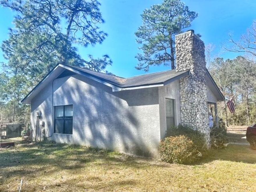 This 3 bedroom 2 bath home is on over 1 acre and South of I-10 off 331 South. This house is made of block and covered with stucco.  The back yard has a fenced area for your pets, Open living room and kitchen. Brick fireplace in the living room. This home has tons of potential. The HVAC was replaced within the last year. This home is located very close to shopping and 25 minutes to the Beaches of South Walton. Buyer to verify all measurements. Schedule your tour today!