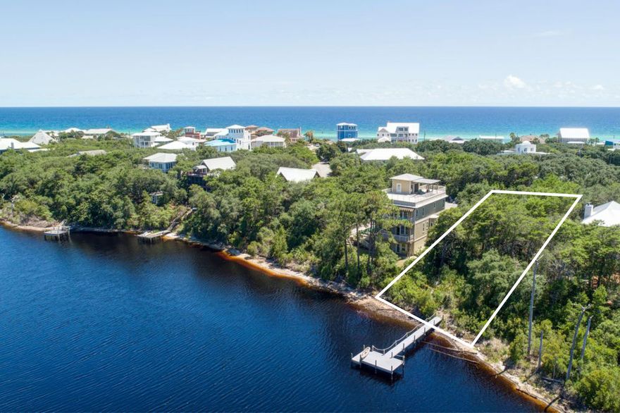 The charming historic community of Old Blue Mountain Beach allows BEACH USE for residents , not just beach access!!  Nestled in this Old Blue Mountain Beach community, the homesite is only one of a few remaining on popular Red Fish Lake.  Situated on a rare coastal dune lake [only a few in the world] that ebbs & flows to the Gulf of Mexico, this property has approximately 75 feet of lake frontage with potential Gulf views from a home.  Boasting Florida live oaks and a beautiful Magnolia tree in a deeply wooded environ, this homesite could host a County height limit of 50' in construction. A nice Trek composite dock allows maximum views and use of the the lake leading to the beach outfall. Jump in your kayak or canoe at the dock for an early morning or sunset paddle!  Only 800 feet to a neighborhood beach access at end of street or paddle or kayak to the beach. Walk to popular Blue Mabel restaurant or the new Cowgirl Kitchen, Red Fish Village, the health food store or Blue Mountain Bakery or Creamery only 1,500 feet away. So many great restaurants and retail establishments only 1/2 mile away.