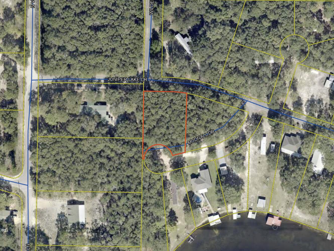 Almost Half Acre At Juniper Lake!! **Motivated Seller** ****High & Dry**** Peace and quiet of rural living just feet away from Juniper Lake and Lake views! Close to all amenities and beaches. Convenience of I -10 to easily get to Pensacola, Tallahassee, Destin Beaches and Panama City Beach as well as shopping, dining, and entertainment. Just 53 minutes from the Beach in Destin! Wooded lot access from two roads. Zoned MH SFR for residential Mobile Homes permitted Or Construct your new build UTILITIES: Electric: Available at street Water Source: Available at street. Tap Needed Sewer: Septic Required