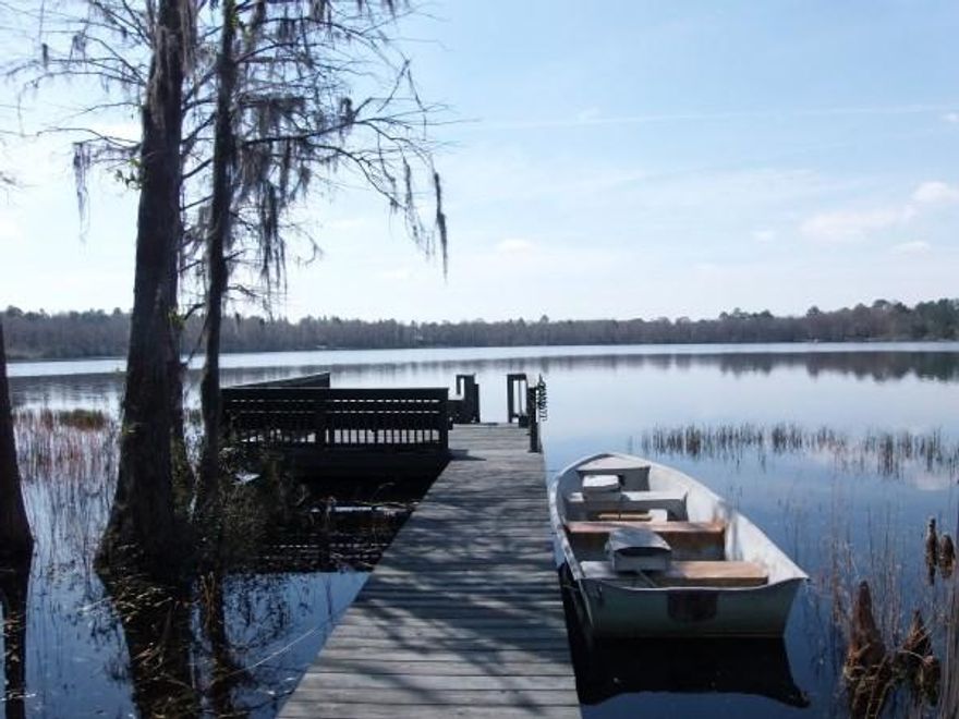 Two homes in one! Ground entry for both levels! You must see this home to truly appreciate what the home & 50 acre Blue Pond Lake has to offer. Put this beautiful 2008 custom lakefront home on your list to see! Blue Pond is a highly desirable private lake with no MHs allowed & one of very few swimming lakes in North Walton County. This 3400 SF home is perfect for the growing or extended family with complete living area on ground level AND in finished basement. There are also oak stairs leading to basement from inside. Ground level features include 156 SF covered porch, 600 SF covered deck overlooking the impressive back yard, walkway, dock & lake; Solid oak floors, custom oak kitchen cabinets, lighting over kitchen cabinets & on ledge of vaulted ceiling in living room...more...