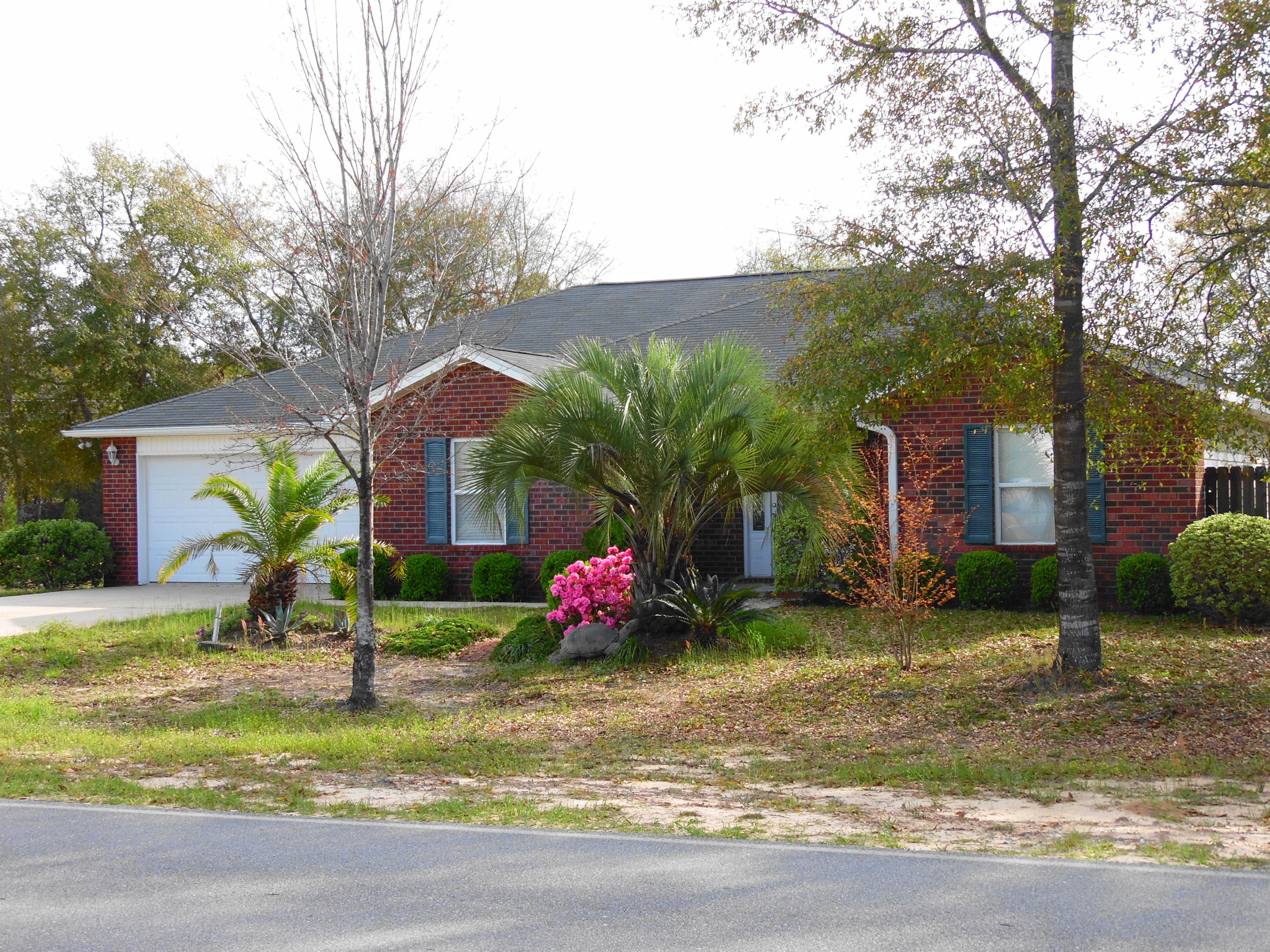 Super buy on this 1500+ square foot home in Mossy Head. 3 bedrooms,2 baths, Cathedral ceilings, great room, kitchen with oak cabinets, breakfast bar, appliances, breakfast room, dining room, inside laundry. Master bedroom has 2 walk-in closets, bathroom has double vanities, separate area for walk-in shower with 2 benches, exit door from master bedroom, to screened back porch, fans with lights in all rooms, exterior has motion detected security lights on each corner. Built in 2006 with 2500 sq. ft. under roof including porches, tile floors and carpet in the bedrooms, 2 car garage, corner lot. Backyard has privacy fence, garden area, own compost pile. This house will qualify for 100% financing, near I-10 exit, 18 miles to Eglin AFB, 20 minutes to Crestview,