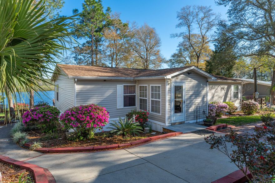 Seller is offering 5k credit with acceptable offer. Lake Life! If you are looking for an awesome home on the sought after King Lake this home is the one for you. This large approximately 580 acre lake is well known for its wonderful fishing and great views. Your new home features some great Lake views off the living area, kitchen/dining area, one guest room and a split bedroom design. Outside you will be greeted with a large covered porch with spectacular views that is perfect for entertaining friends and family. So grab your rocking chair and fishing poles and hit the dock and get ready to enjoy your own backyard oasis that most people only get to dream about. To top things off you have a wonderful multi purpose garage with covered parking, a bathroom, and the perfect covered patio