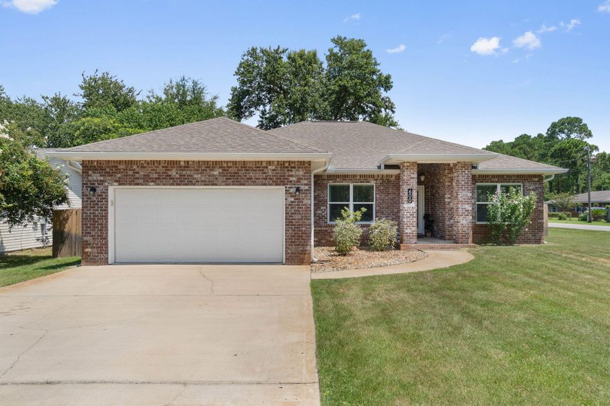 Welcome to your new home! This spacious 4-bedroom, 2-bathroom residence built in 2014 sits on a large corner lot in Mary Esther just 10 minutes from Hurlburt Field and with no HOA! For peace of mind, enjoy updates like a new irrigation system (2022), water heater (2022), and HVAC system (2021). Step inside to find 10-foot ceilings, wood-look tile flooring throughout, and a bright (thanks in part to the newly added and upgraded lighting!) open-concept living, dining, and kitchen area perfect for entertaining. The living space includes built-in surround sound, while the kitchen showcases granite countertops, stainless steel appliances, a breakfast bar, and plenty of tall cabinet space. The split bedroom layout ensures privacy, with the primary suite featuring a tray ceiling with crown molding and stunning accent wall and in the owner's bathroom dual vanities with granite counters, a spacious walk-in tiled shower, and a large walk-in closet. Outside, you'll love the fully fenced backyard and the impressive 26' x 10' screened-in patio - a fantastic spot for entertaining or relaxing year-round. This move-in ready home combines comfort, convenience, and value. Schedule your private showing today!