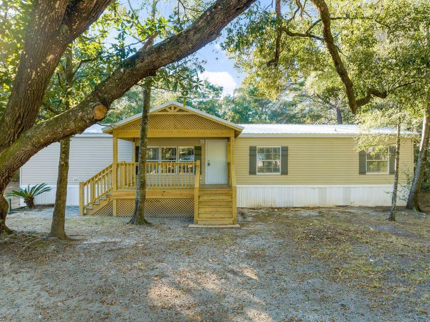 Step into this cozy extensivley renovated double wide mobile home which welcomes you with a rustic fireplace at the door. The primary suite features a tub and separate shower, with a walk in closet. Venture into your backyard which boasts beautiful oak trees and wooded nature. This home sits perfectly on a double lot in the up and coming city of Freeport which is ideally located between both the beach and the bay. Enjoy a short commute to all local shopping and dining as well as close proximity to Publix. This double lot offers the unique ability to purchase the back half of the lot separate to the home as well as the front half of the lot. This lot is perfect for a primary home owner or an investor looking to get into the community before the boom