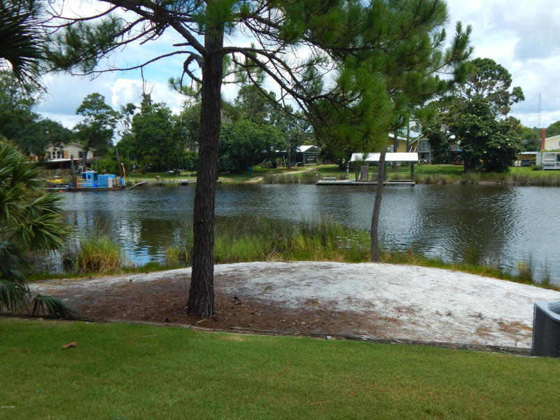 Excellent opportunity for a vacation home, primary residence, or for a resort rental investment. Lagoon front condo with access to the Gulf & a beautiful view in a community with many amenities-- pool, dock , tennis courts, & much more. All of this & less than 2 blocks to the beach. Located on the east of Panama City Beach convenient to the marinas, great restaurants, entertainment, & the Navy Base. Villas of St. Thomas is nestled in a quiet gated communty, but is very close to all of the activities available at Panama City Beach. This 1st floor condo is perfect for walking right out from your covered patio to Grand Lagoon. Vacation rental with very good income potential. All information & measurements are approximate & should be verified if important.
