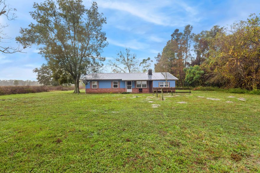 in the heart of Chiefland, Florida, on 4.7 acres of pure serenity. This enchanting home located just off a paved road features 3 bedrooms and 2 bathrooms, This property is located in Levy County,  just 16 min from Manatee Springs Boat Ramp on the Suwannee River also 26 min minutes from Cedar Key on the Gulf of Mexico,  48 min from Crystal River Fl and one hour of Gainesville Fl, Schedule your appointment to view this country home today