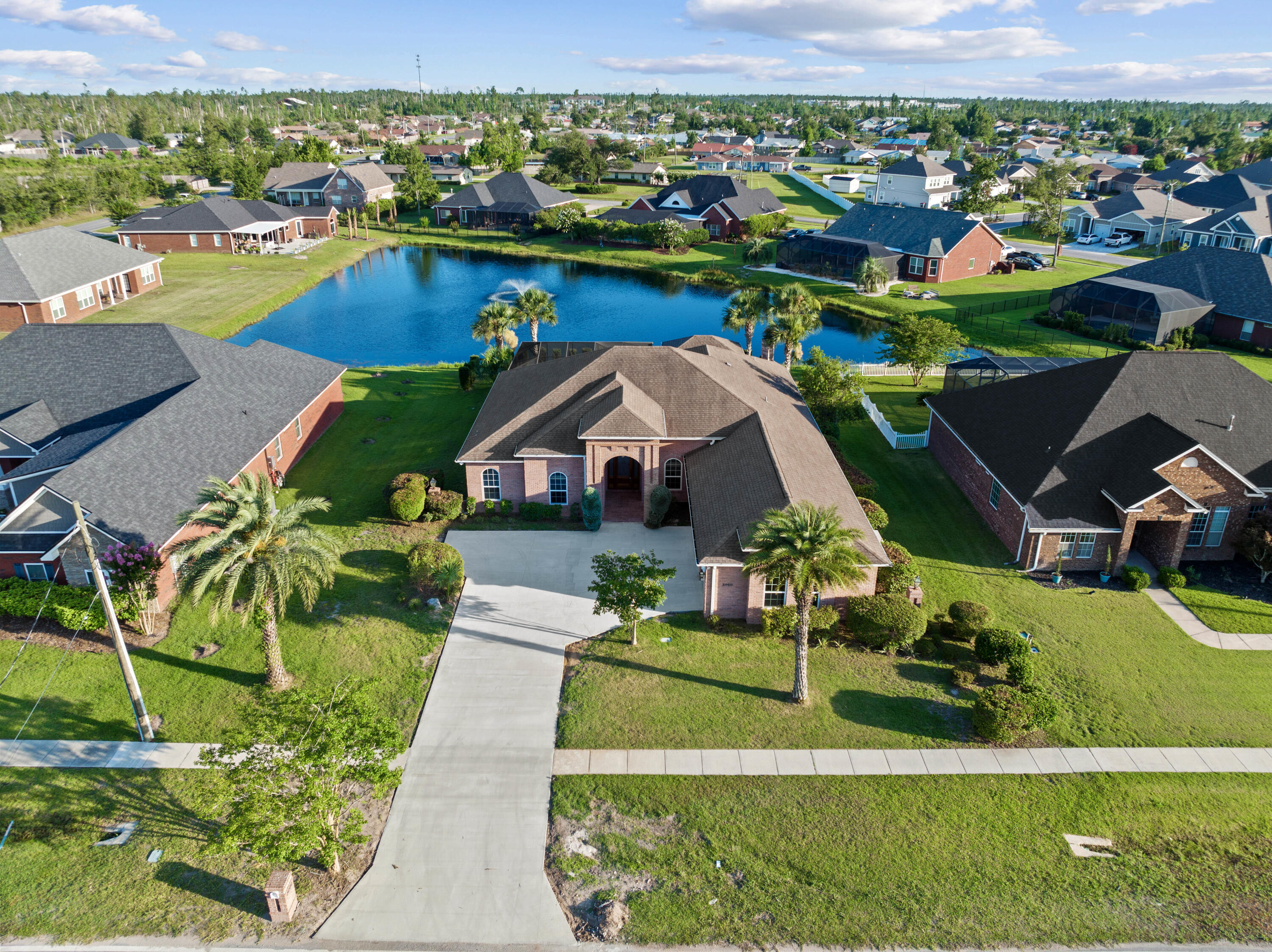 Poised perfectly in the heart of the College Point community, this custom home WITH A POOL offers it all. Over 2,700 square feet in a convenient one-level, split floor plan, this home boasts 4,000+ square feet under roof. The outdoor living was made for the entertainer with a heated saltwater pool, spa, covered lanai and a summer kitchen fit for a Chef. This unique entertaining space spared no expense with a professional gas grill, deep fryer and multiple sink stations. Enjoy the sounds of the fountain in the pond while you watch the sunset around the wood-burning fireplace, which is ideal year-round. Enter the newly poured concrete driveway in this custom-built home and you're greeted with 3 oversized garage bays, complete with professional storage solutions for tools/equipment.