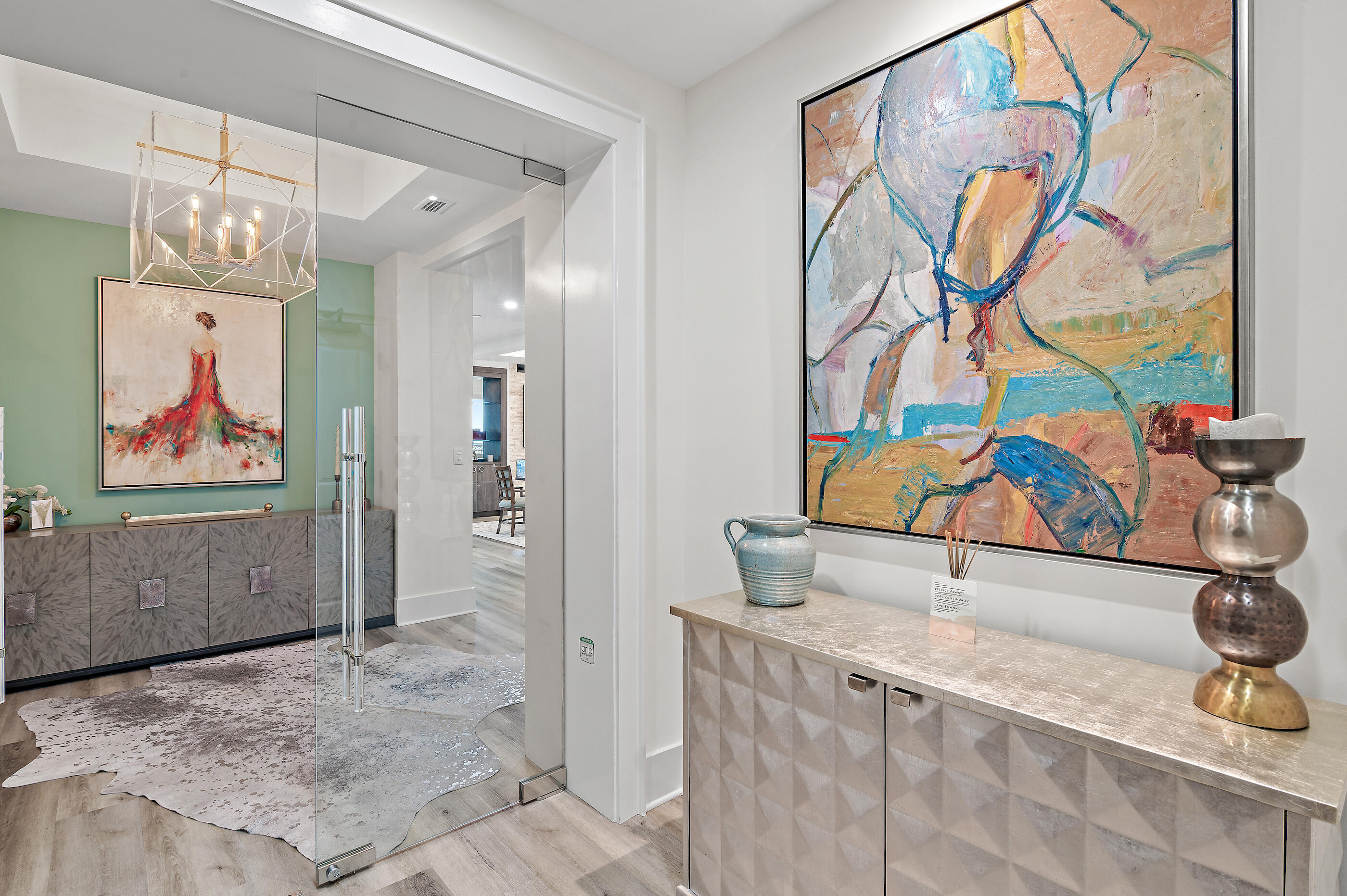 From the moment you step inside, you'll know this is more than just a home-it's an experience. Custom glass doors open to soaring ceilings, walls of natural light, and sweeping views of the Bay, golf course, pool, and lush green spaces. This 3,008 sq. ft. Edgewood residence in One Water Place (Building 2) has been completely reimagined with a modern, open layout - walls and columns removed for a seamless flow that blends elegance with comfort. A lighted, two-sided linear gas fireplace anchors the living space, setting the tone for cozy nights or stylish entertaining. The showpiece kitchen features custom cabinetry, a massive 12' x 4' quartz waterfall island, a sleek wet bar, and all-new Thermador appliances - induction cooktop, wall oven, speed-oven/microwave, beverage center, ice maker, and dishwasher- making it a true culinary hub. Every finish has been thoughtfully curated, from the new flooring throughout (including both balconies) to the marble bath and shower tiles. The primary suite feels like personal spa retreat , with a steam shower, multiple shower heads, and a Toto Washlet. Smart features abound - LED and Lutron lighting you can program to set the mood, motorized Hunter Douglas window treatments, and upgraded plumbing fixtures. California Closets maximize storage, while both balconies have been transformed with modern tile, a summer kitchen, Blaze gas grill, and Blaze 2-drawer refrigerator-perfect for soaking in the views. Plus, there's a 12' x 14' storage space at garage level for all your extras.