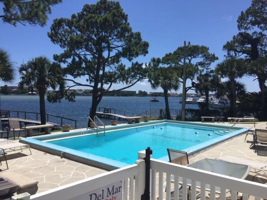 This lovely end unit townhome is located in a small waterfront complex within walking distance to the Fort Walton Beach Downtown District with many shopping, dining, and pub options. A beautiful soundfront pool as well as reserved parking right outside your front door. Two docks for fishing and temporary mooring available. The perfect spot to enjoy all of the fireworks displays over Santa Rosa Sound. Very convenient location. Cute back patio area with gate access on this end unit.