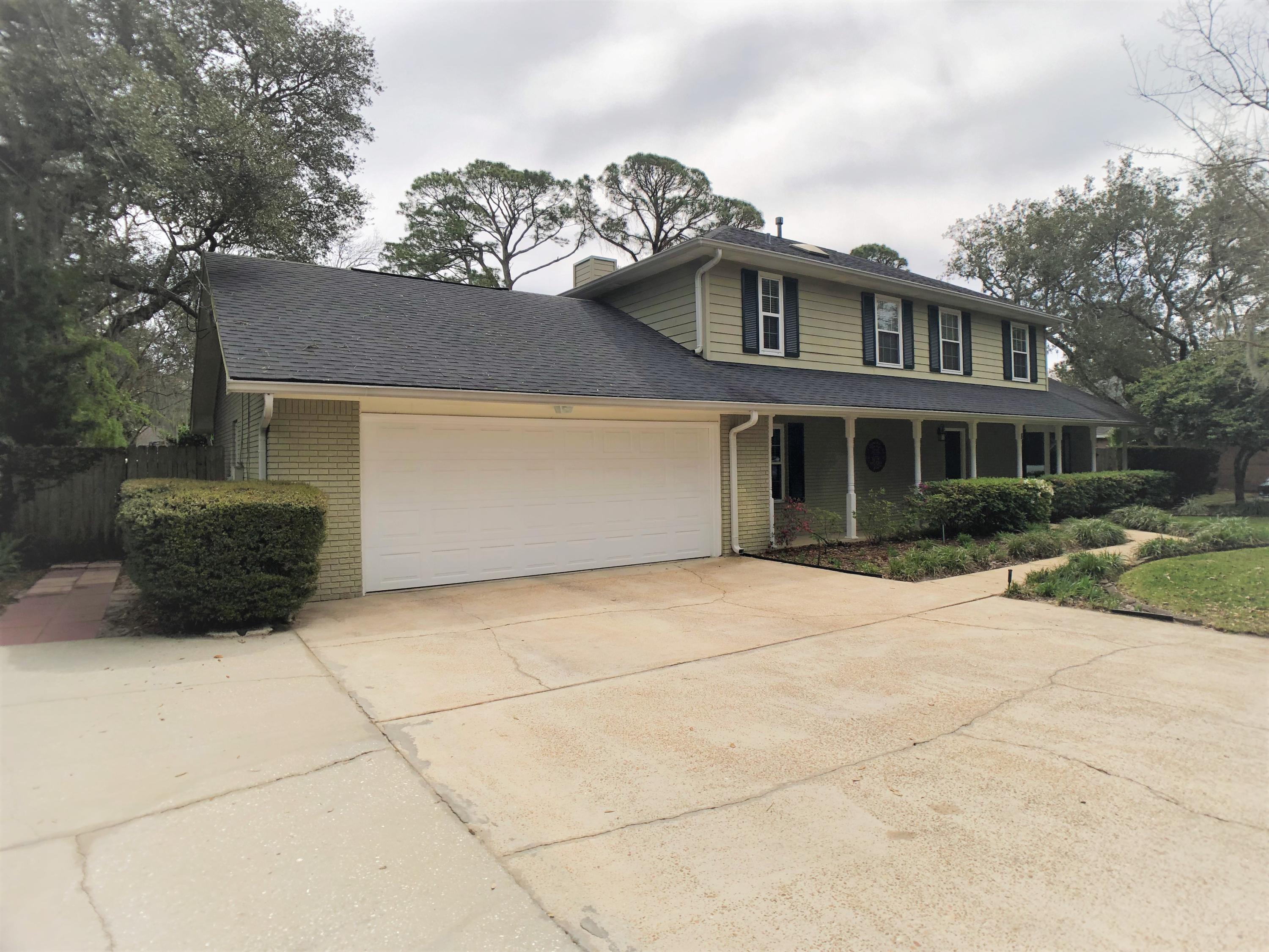 This beautiful and perfectly-maintained home is tucked back in quiet Shady Lane subdivision with water easement access for kayaking & paddle-boarding. House has all NEW Hurricane-rated windows and exterior shutters! This home features hardwood floors & tile with NO CARPET, new quartz counter tops, bedroom on the first floor that can double as an office, a huge screened-in FL Room that is perfect for entertaining or relaxing! Other features include large baseboards, gorgeous tile shower in master bath, washer/dryer has gas & electric hookups. HVAC condenser is 2 yrs. old, kitchen disposal is new.. Both front & back yards have lush landscaping that adds beauty & privacy. NO FLOOD INSURANCE REQUIRED! House is high & dry. Large 2-car garage with cabinetry/workspace area w/ utility sink.