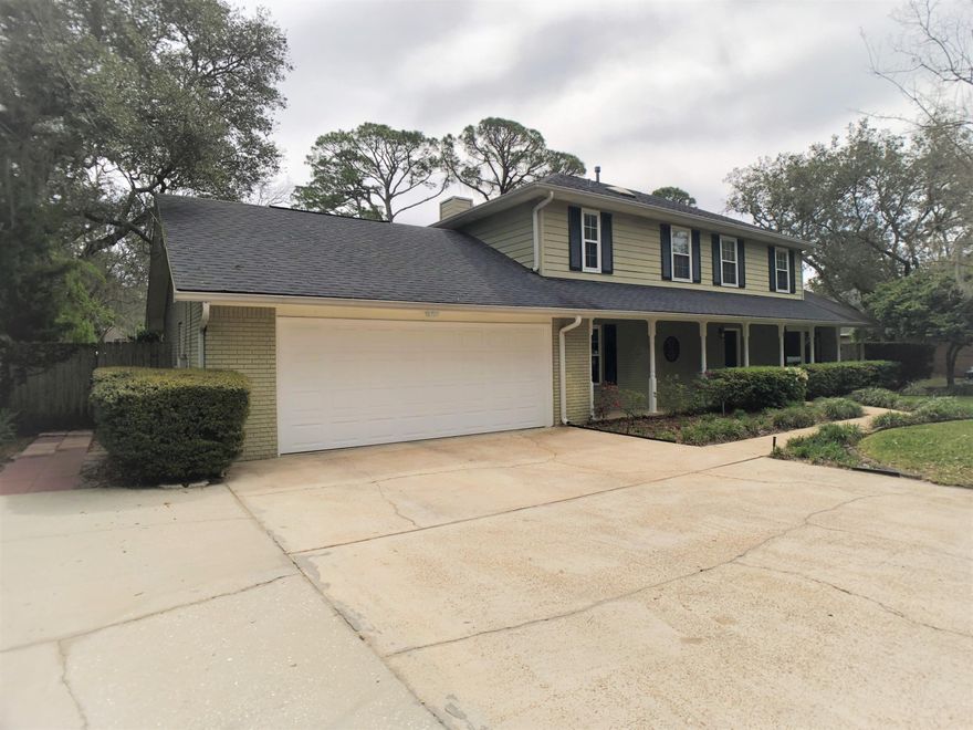 This beautiful and perfectly-maintained home is tucked back in quiet Shady Lane subdivision with water easement access for kayaking & paddle-boarding. House has all NEW Hurricane-rated windows and exterior shutters! This home features hardwood floors & tile with NO CARPET, new quartz counter tops, bedroom on the first floor that can double as an office, a huge screened-in FL Room that is perfect for entertaining or relaxing! Other features include large baseboards, gorgeous tile shower in master bath, washer/dryer has gas & electric hookups. HVAC condenser is 2 yrs. old, kitchen disposal is new.. Both front & back yards have lush landscaping that adds beauty & privacy. NO FLOOD INSURANCE REQUIRED! House is high & dry. Large 2-car garage with cabinetry/workspace area w/ utility sink. House has a convenient mud room off garage & back door.  Just replaced 1st story roof with exception of areas above screened in porch & breakfast nook.  House has plenty of extra parking along side of driveway.  Seller has termite bond & survey transferable to buyers at closing.  Fireplace is sold "as is" ... will take little work to make functional!