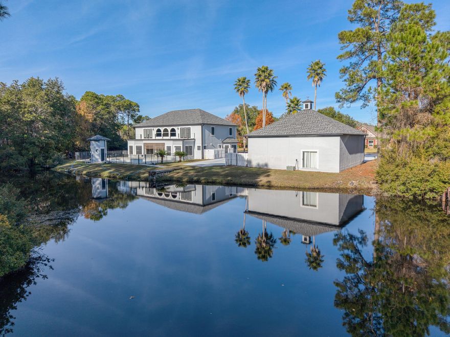 Welcome to this tranquil pool home, situated on a one-acre lot with serene lake views! Located in Hidden Creek with quick access to East Bay Blvd, this updated home offers a 2025 roof, 2 new AC units (2023 & 2025), a completely renovated kitchen, and a pool with a brand new liner! Upon entering the nearly 5,000-square-foot residence, you're welcomed by a grand staircase, porcelain tile plank flooring, and a spacious, light-filled living room featuring soaring ceilings and large windows overlooking the pool and pond. The beautifully updated kitchen showcases luxury appliances such as a Bosch dishwasher, Dacor fridge, an induction cooktop, cafe double ovens, granite countertops, an island with an extended breakfast bar, and dual sinks. A butler's pantry connects the kitchen to the formal di ning area and laundry room (enabled with a laundry chute from upstairs!). The primary suite offers space for a sitting area and a bathroom complete with a large walk-in closet, a cedar sauna and double vanities. A versatile bonus space on the main level provides the perfect setup for a home office, gym, or playroom. Upstairs, you'll find four spacious bedrooms, two full bathrooms, and a substantially sized bonus room. Select bedrooms open to a large balcony overlooking the peaceful lake and woods. Outside, enjoy a covered porch, a sparkling pool (pump and sand filter replaced 2023), private fishing pier, and a pool house bathroom! The property has a detached three-car garage, set up with a circuit for electric car charging and extra attic storage. The back of the garage has the potential to be converted into space for boat or RV storage. Hidden Creek offers exceptional amenities, including a golf-course, a clubhouse, multiple pools, a fitness center, a boat ramp and pier, a soundside beach area, and a variety of children's programs. (See MLS docs for full list of amenities & home's upgrades) This is a rare opportunity to enjoy luxurious living in a serene setting!