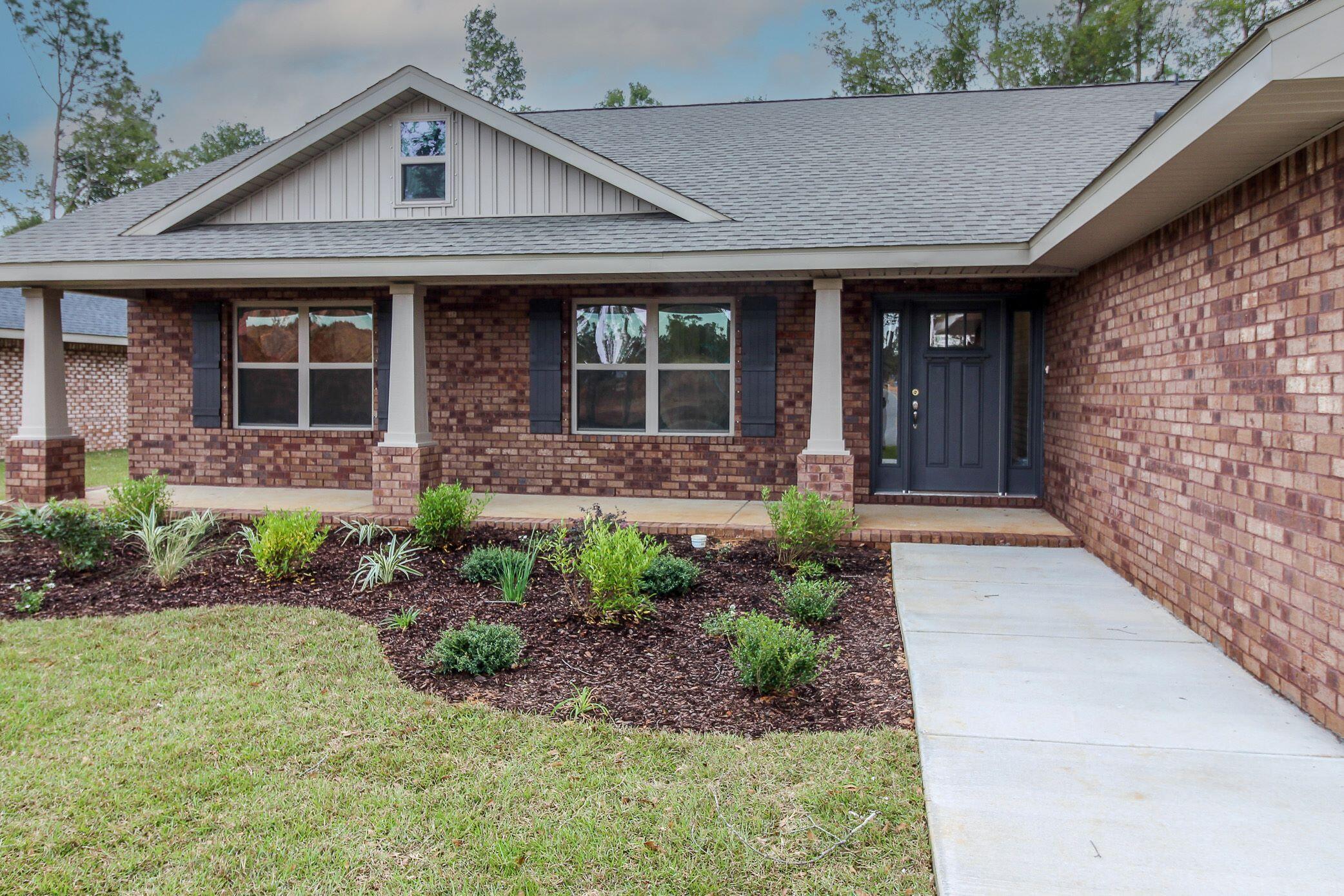 This home is 4 sided brick and comes with sprinklers and a fully sodded lot with professional landscaping. It also features a 10' x 20' covered back porch! This is a split bedroom plan and the master comes with a beautiful en suite that has double vanities as well as a walk in shower and garden tub. All countertops in both bathrooms and kitchens are with granite and all wood cabinetry in a modern gray tone. The kitchen has a nice breakfast bar and an open dining space. The great room has a cathedral ceiling and the back porch can be accessed through this room. The floors are adorned with Puretec Plus flooring which is a durable LVP. All bedrooms have carpet. Appliances are stainless frigidaire. This subdivision is quiet and this home sits in the back.Many more features to mention!