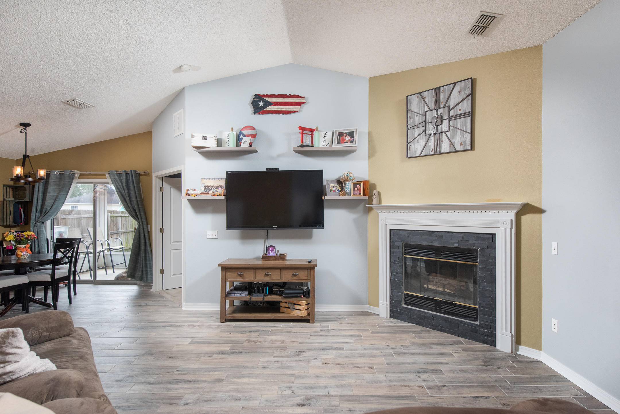 Welcome to this cozy home located in the heart of Navarre. Resting on a large corner lot, this centrally located home is within minutes to everything you need. Enjoy a day at the beach or dine at some local favorites, all in close proximity. Upon entering, you will find new tile flooring, upgraded fireplace, & newly renovated bathrooms. This open floor plan is ideal for gathering with family & friends.The large tv, floating shelves, and the washer & dryer are an added bonus. Make your way to the master bedroom with a large walk in closet, & master bath with new vanities and light fixtures. Enjoy a cup of coffee in the mornings on your screened in porch & a glass of wine in the evenings by the fireplace. Call to schedule your private tour before you miss your opportunity!