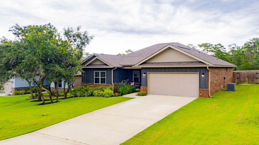 Built in 2018 residing on almost half an acre,tastefully appointed home has so many wonderful features you're sure to love! Upon entering, you'll note the luxury vinyl plank flooring throughout, spacious open floor plan and high ceilings. The kitchen comes equipped with gorgeous white Quartz countertops, modern silver glass subway tile backsplash, soft close cabinetry, under cabinet lighting, island with breakfast bar, walk-in pantry, stainless steel appliances and refrigerator with ice and water dispenser. The oversized master suite invites a separate sitting area or would be ideal for nursery. The master bathroom has a gorgeous walk-in shower with a double Quartz vanity, soft close cabinetry, water closet, shelving for linens and a large walk-in closet. The closet connects to the laundry room for your convenience. The additional 3 bedrooms and bathroom are located on the opposite side of the house offering privacy for the master suite. The second bathroom also has Quartz counter tops and soft close cabinetry with a shower/tub combo. You'll also enjoy the covered lanai with ceiling fan and fully fenced back yard with a privacy fence with a back gate that leads to the remaining yard with a double side gate perfect for boat storage. Other notables are hurricane protection, finished garage, NO HOA, located in flood zone X, termite bond, Levelor blinds throughout, sprinkler system on a well, recessed lighting, walk-in closets in 2 of the other bedrooms and pull down attic stairs for additional storage. Located just a 5 minute walk to the Bay, 20 minutes to Pensacola beach and 3 miles to Publix, Lowes, Wal-Mart and more shopping and dining. Check out our full video tour on the MLS and YouTube.