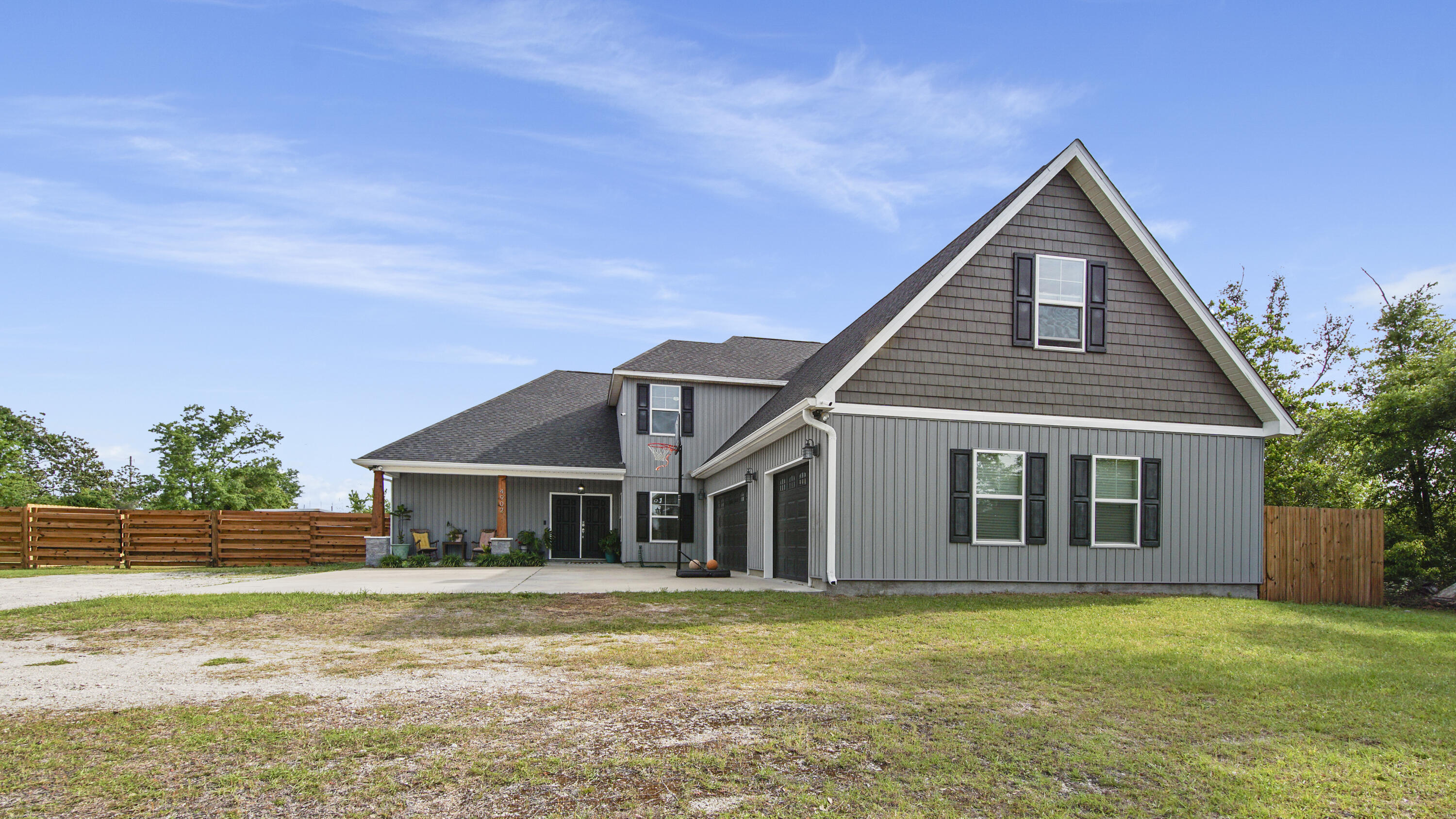 Nestled in Panama City's serene Deer Point area this stunning 2-story Craftsman style home built in 2018 must be seen to be appreciated. Spaciousness abounds with just under 3300 sq.ft. of luxury living. Boasting 5 BR, 3 full baths, an office, an oversized 3-car garage, and large bonus room, it's a haven of comfort. The wraparound veranda with cable hookup helps complete just over 5200 sq. ft. under roof and opens to the large backyard with garden to enhance its allure. Inside, cathedral ceilings in the living room open to the dining room and the tastefully designed kitchen which includes stainless steel appliances, self-closing cabinetry, and granite countertops. The owner's suite pampers with quartz countertops, an oversized 6ft jacuzzi tub, walk-in tiled shower, and walk-in