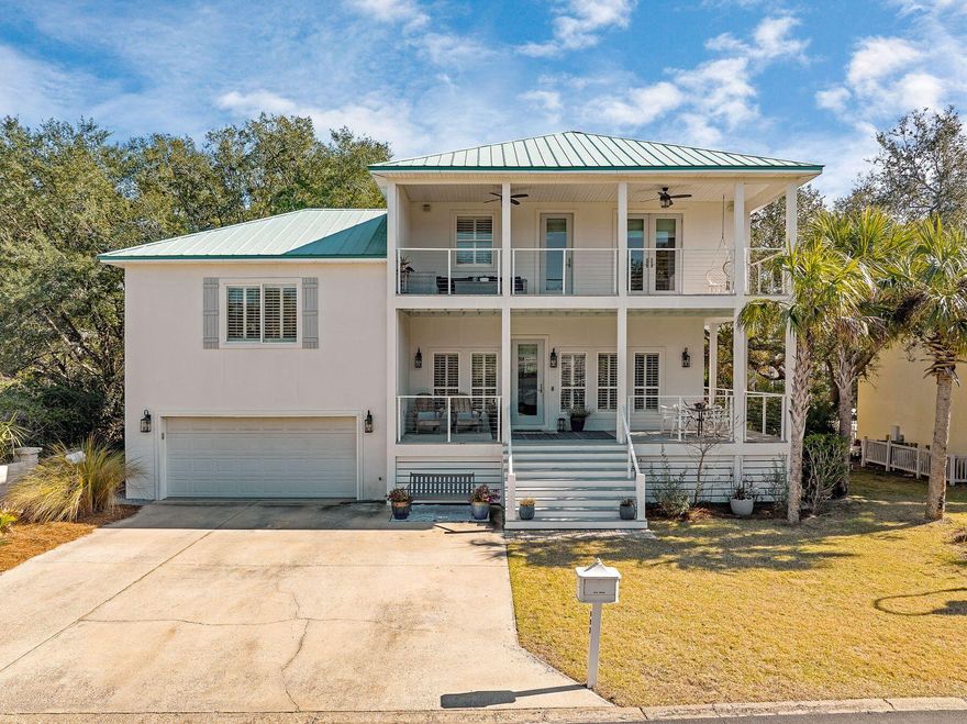 Set behind the gates of a quiet looping drive, this fully renovated lakefront home offers a way of living that feels both relaxed and elevated. Updated from top to bottom in 2020, the residence pairs designer finishes with an easy coastal rhythm centered on the water, the trees, and the ability to step outside and simply go.The main living space is light-filled and open, anchored by a chef's kitchen designed for real life and effortless entertaining. Dual custom islands create space to gather, prep, and linger, while quartz countertops, a gas range with pot filler, and upgraded stainless steel appliances bring form and function together. The flow from kitchen to living area feels natural and inviting, whether hosting friends or settling in after a day on the lake. The primary suite is a true retreat, offering calming water views, a private balcony, and a spa-inspired bath that feels removed from the everyday. Upstairs, two additional bedrooms and a full bath provide comfortable accommodations, while the ground-level studio adds flexibility for guests, work-from-home needs, or a kids' hangout.

Outdoors is where this home truly shines. A tiered backyard framed by mature oaks opens to multiple porches and a private dock, making it easy to load a paddleboard, pack a cooler, and glide across the lake toward the beach or linger for sunset drinks on the water. The setting feels peaceful and established, with a sense of privacy that is increasingly rare.

Life here extends beyond the property lines. Neighbors gather for cookouts, boat parades mark the Fourth of July, seasonal paddleboard traditions bring the lake to life, and kids play freely in the street. At the same time, coffee shops, restaurants, shopping, and everyday conveniences are all within an easy walk, offering the rare combination of lakefront calm and coastal accessibility. This is not a rental scene, but a genuine community with a warm, lived-in feel that makes it easy to imagine staying for a while.