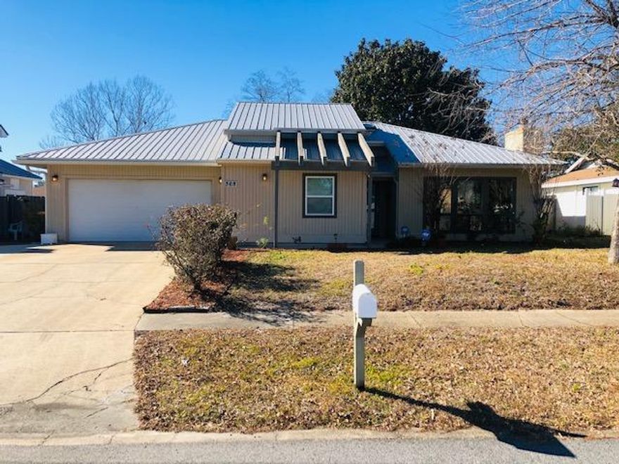 This lovely cottage style home in the heart of Destin is a must see!!! It has so much charm with an open floor plan, vaulted ceilings in the living room and dining room, a stone faced wood burning fireplace and beautiful wood flooring. It has a metal roof and both the kitchen and bathrooms have been recently remodeled.