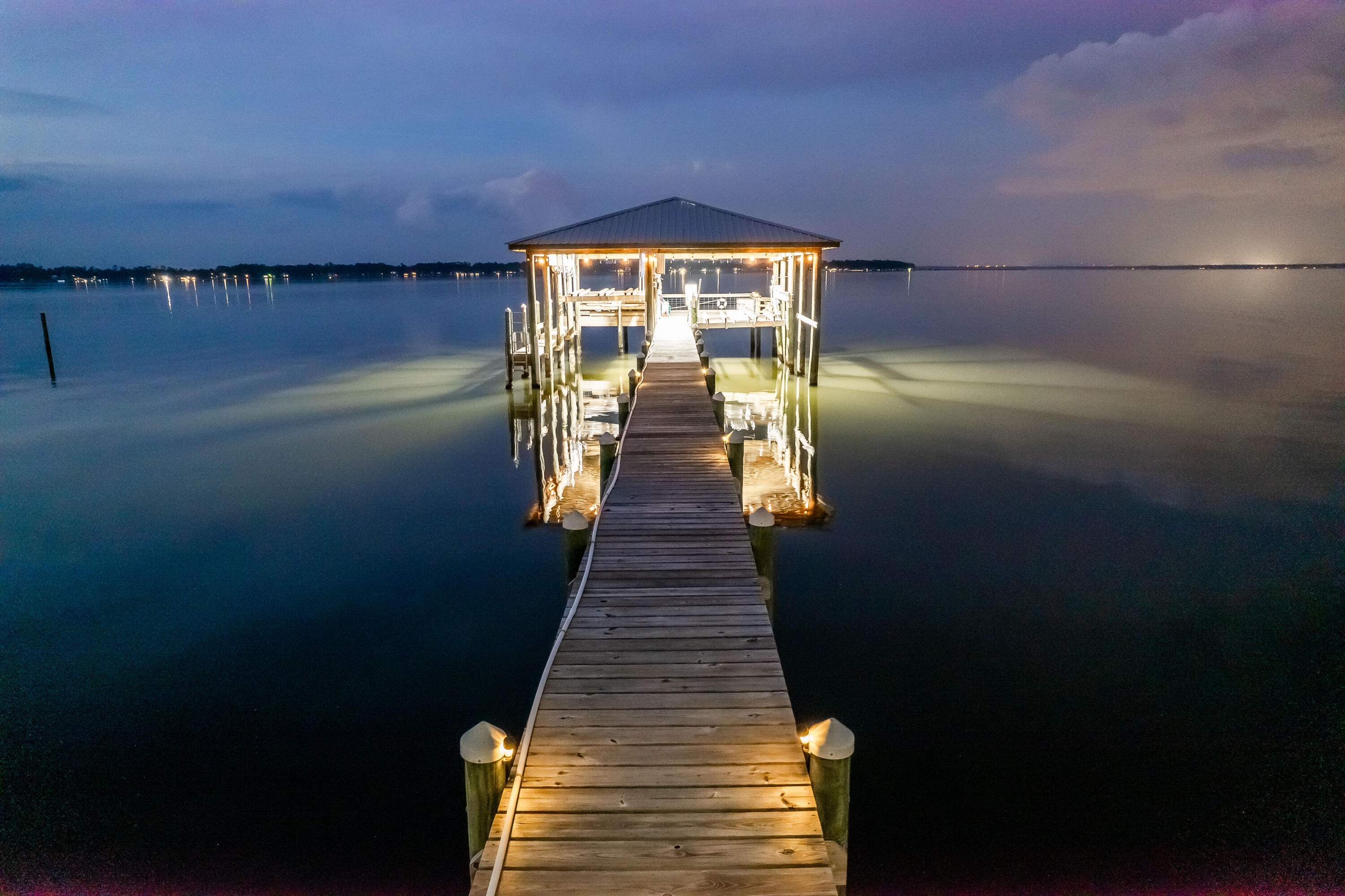 Back on market at NO fault to the sellers! Located in the community of Paradise Beach, this spacious custom-built home resides on a large waterfront lot and features a large screen enclosed lanai (48x36) surrounding an in-ground gunite saltwater pool with ample space for seating, perfect for entertaining guests. The open, split floor plan allows for 2 offices, 2 dens, and a bonus room that makes a perfect media room. The kitchen comes equipped with ample cabinet storage, a 5-burner gas cooktop with Thermador downdraft, a new Kitchen Aid fridge with an ice and water dispenser, a breakfast bar suitable for three people, and a built in wine fridge. The primary suite is suitable for a king-size bed and features water view