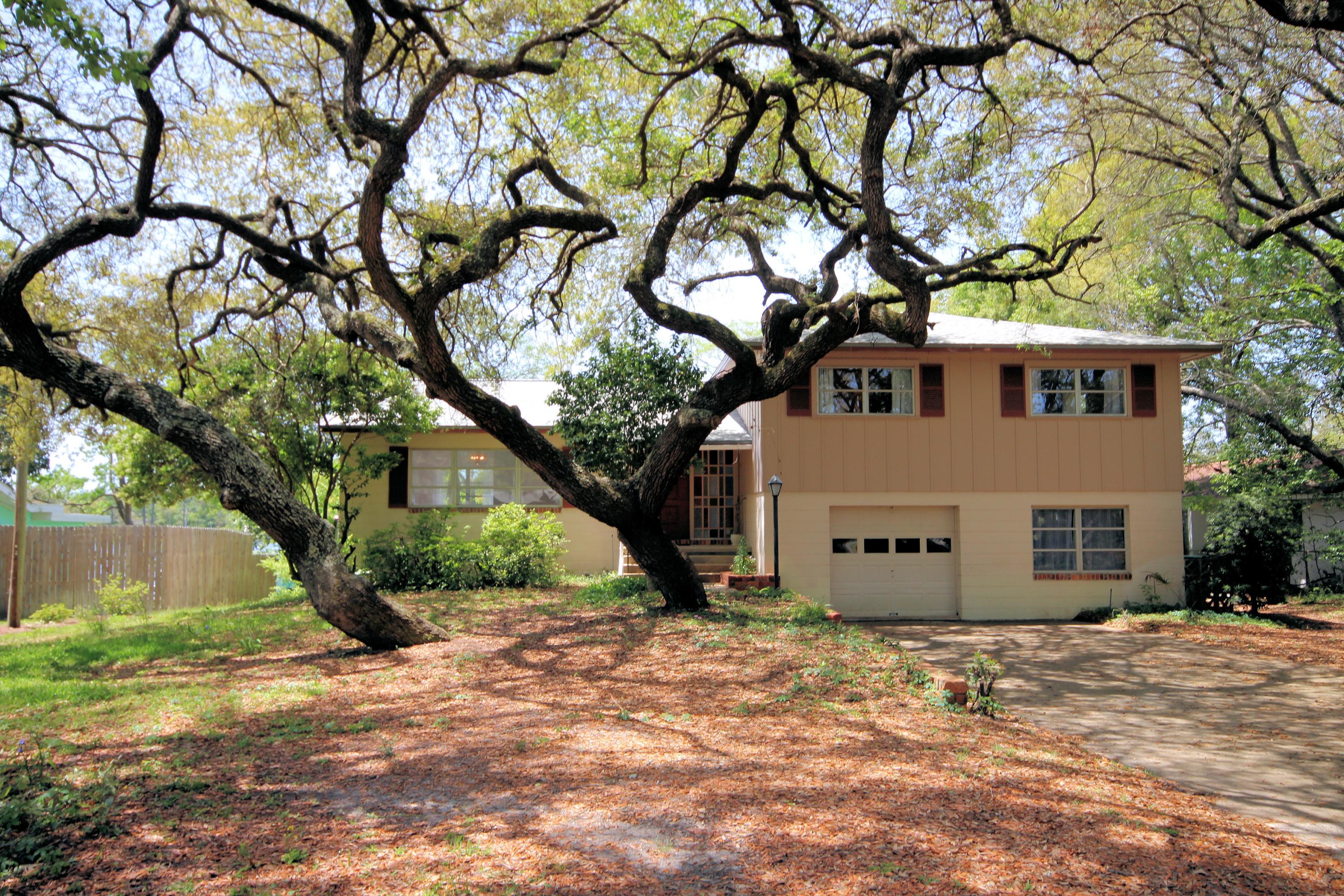 Waterfront living at it's best! 95 feet of Cinco Bayou waterfront and what views! Newly refinished Hardwood floors in dining/living area. Split level home with four bedrooms (hardwood floors) and two full baths on upper level and a fifth bedroom or office (with separate entrance) and adjoining bath on first level. Enjoy cool breezes on the 26'X 12' screened covered patio overlooking Cinco Bayou. Half acre lot provides privacy. Sea wall with rip rap along water's edge. Freshly painted walls and stone floor foyer greets you! Eat in kitchen with water views. Large 25' X 10' family room downstairs has Terrazzo floors and one wall with a dramatic stone wood burning fireplace and large mantel. Single car garage and plenty of storage in basement. New Roof June 2015.Bayou leads to Bay and Gulf.