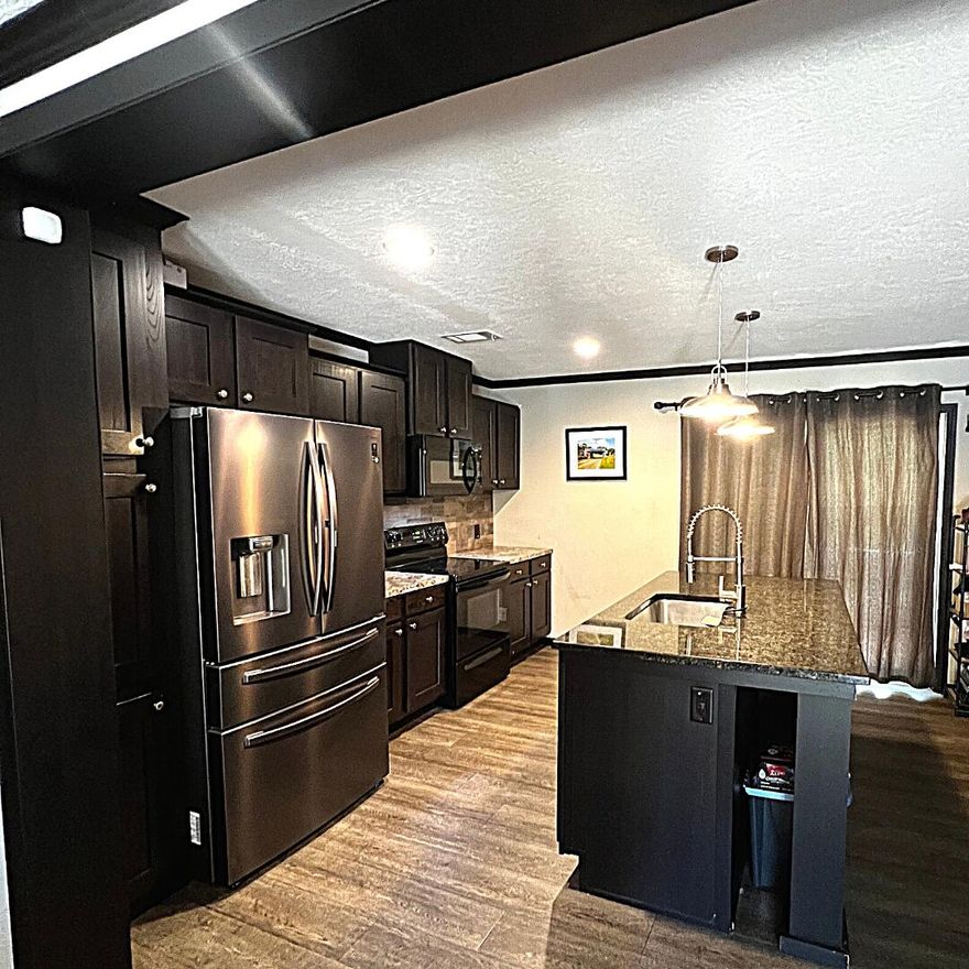 MOTIVATED SELLERS, FINAL PRICE IMPROVEMENT! The home's open floor plan provides two living areas, a dining area with a built in cabinet perfect for a breakfast/coffee station, and kitchen with a beautiful granite topped island. The split-floor plan puts the Owner's Suite in the perfect place for privacy. On the opposite end of the home is the large 2nd bathroom, 3 additional bedrooms with walk in closets, and a large utility room with built in cabinets and desk. Worried about storms? No sweat, the home has a reliable Briggs and Stratton 18KW automatic standby generator, with automatic standby 200 amp transfer switch and 250 Gal. LP tank. At 100% usage, with full tank, the generator will keep this home powered for approximately 7 days.