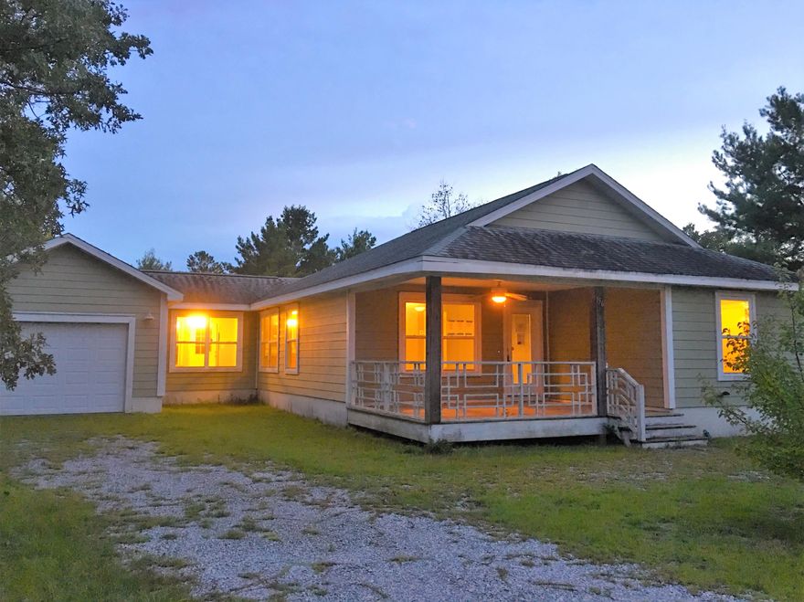 REO Features a large covered front porch and rear deck. upgrades include tileed flooring in living areas and laminated wood look flooring in all bedrooms,maple wood cabinets,.This floorplan includes an additional room between the garage and kitchen that could be an office, tv room. Living area has a VAULTED ceiling and windows everywhere to let in the light.Master has wood look laminate flooring,treyed ceiling,ceiling fan & walk in closet.The masterbath has tiled flooring, linen closet & a cultured marble vanity. Exterior is hardy plank siding with upgraded multi dimensional shingled roof.