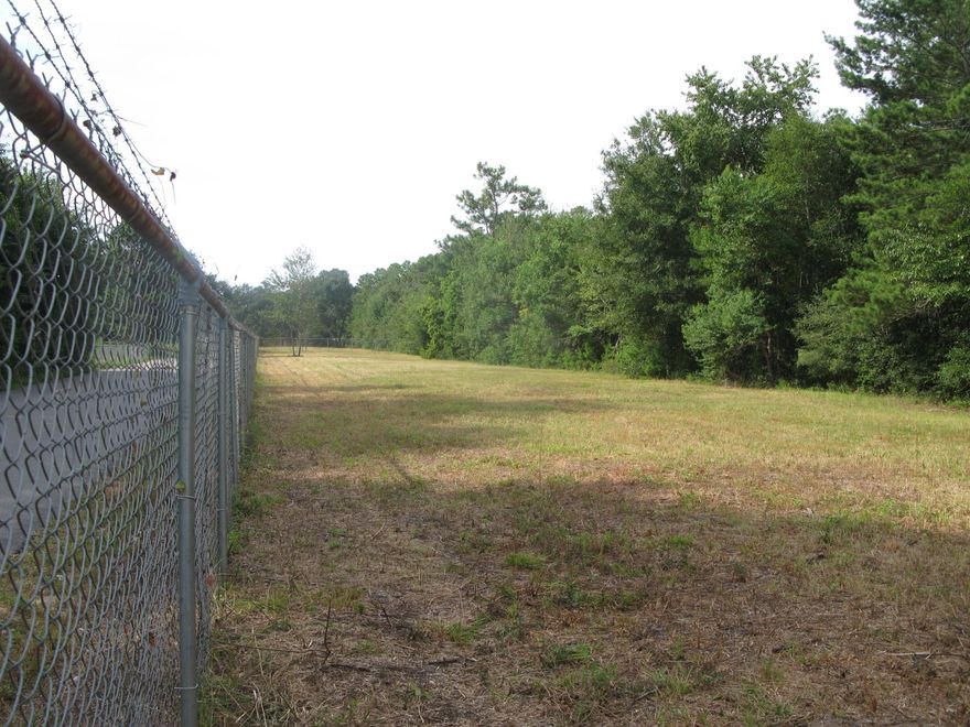 cleared level fenced in lot. Borders Hurlburt AFB Commando Village residential community. Zoned Mixed Use. Ideal spot for townhomes or patio homes.