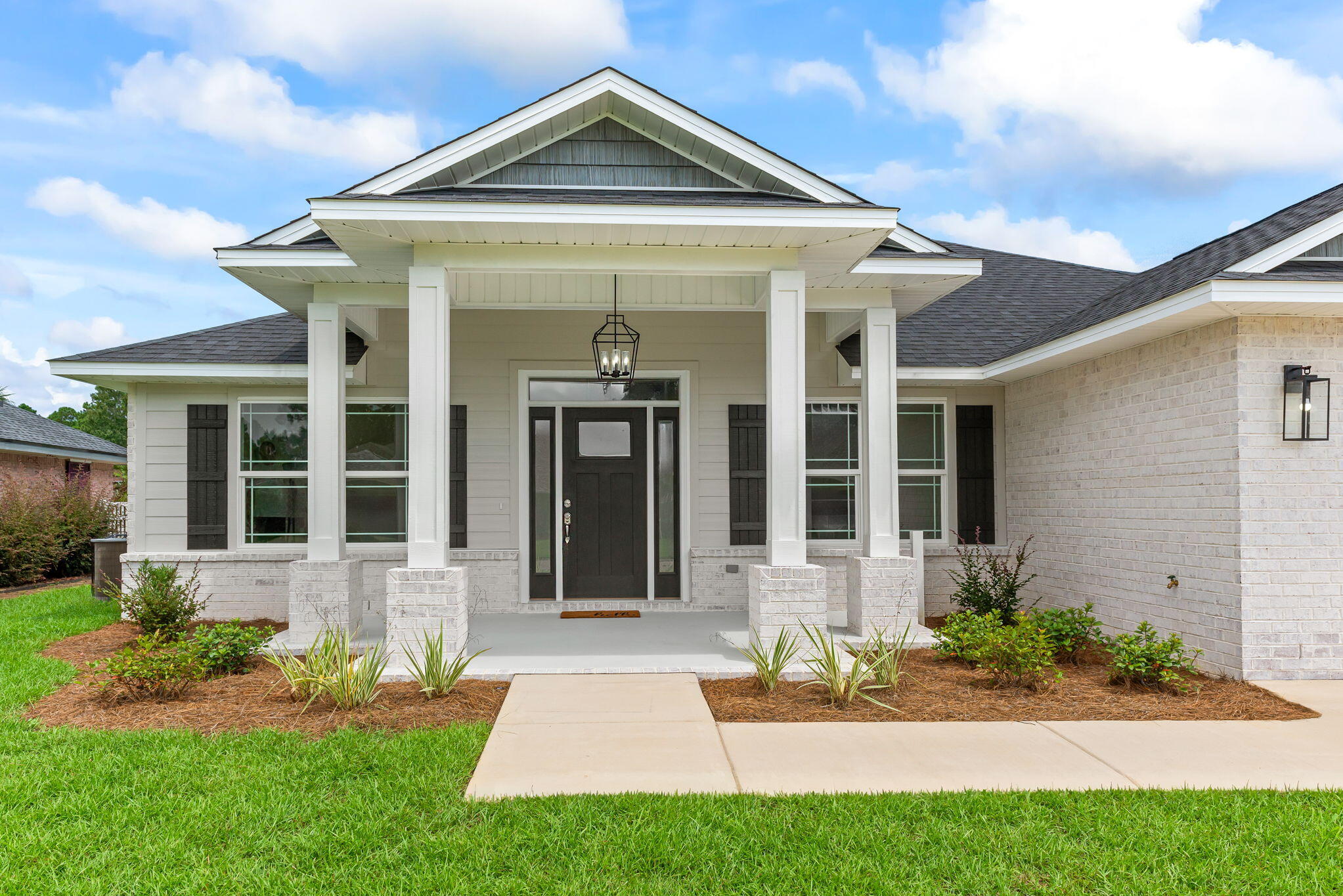 Under Construction!! NEW HOME!! Welcome to this stunning 5-bedroom, 3-bathroom craftsman-style home offering 2,236 sq. ft. of modern living space in the heart of Navarre. Designed with comfort and style in mind, this open floor plan features trey ceilings, luxury vinyl plank flooring throughout, and upgraded lighting to create a warm and inviting atmosphere. The spacious kitchen is a chef's dream with a farmhouse sink, quartz countertops, beautiful tile backsplash,stainless steel appliances, recessed lighting, and under-cabinet lighting--perfect for everyday cooking or entertaining guests. Retreat to the owner's suite with its private bath, while four additional bedrooms offer space for family, guests, or a home office. Step outside to enjoy a covered back porch overlooking a landscaped yard with a sprinkler system, ideal for relaxing evenings or weekend barbecues. A double-car garage with garage door opener and pull-down attic stairs provides convenience and extra storage. Located close to beaches, shopping, and Hurlburt Field AFB, this family-friendly home combines modern upgrades with a prime location.