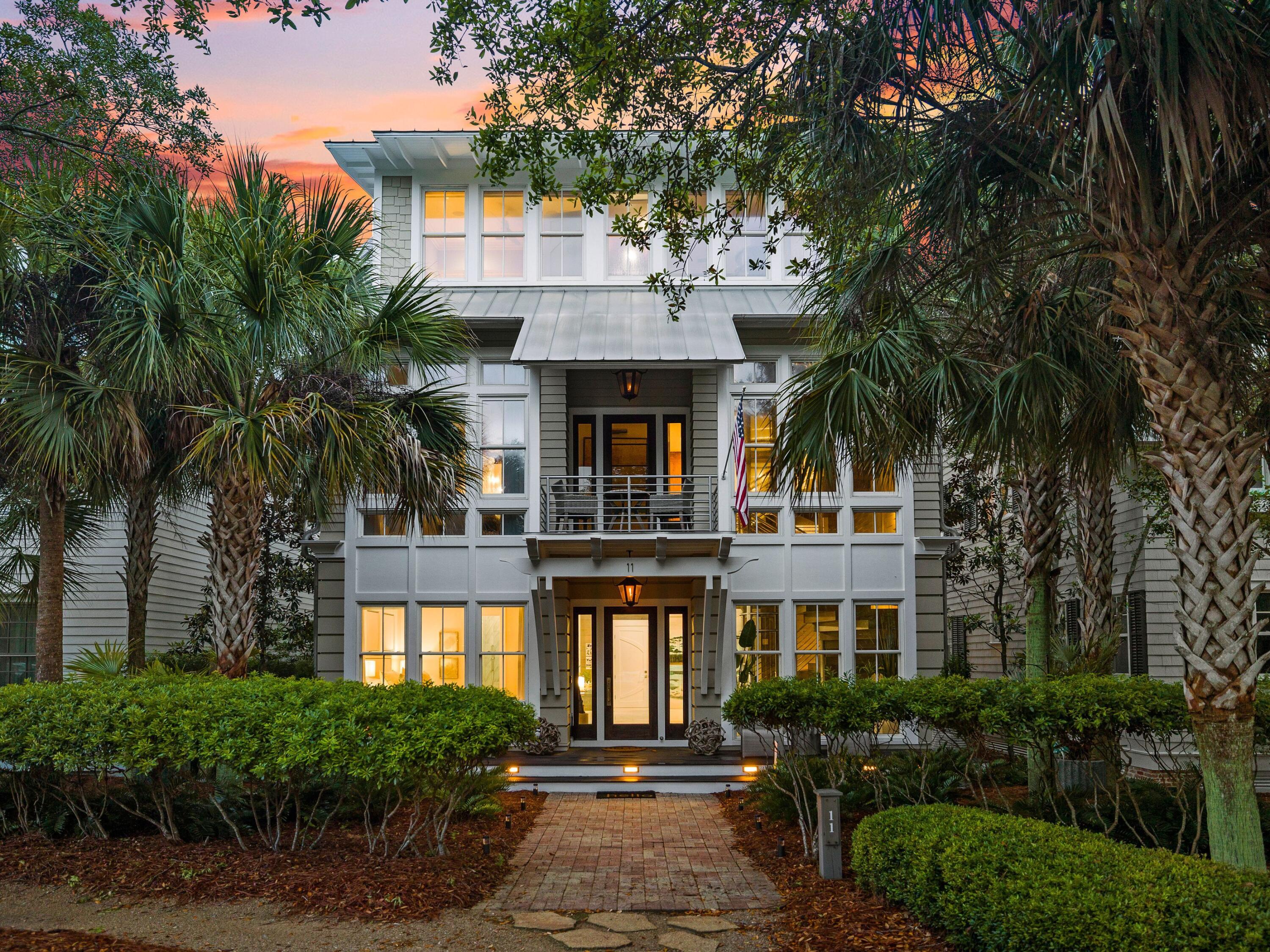 This contemporary WaterColor home has it all, including lake views and an enviable array of luxury upgrades. A brick-paved path leads to the covered front entrance, which opens to reveal a surprisingly modern home with a marble atrium and curving staircase wrapped around a futuristic glass elevator. Two guest suites, a custom bunk room and a two-car garage take up the first floor. Spread over four levels, this sophisticated home has walls of glass windows flooding the living space with natural light and framing pleasing preserve and lake views. The second level has a spacious open dining area, living room and bar equipped with twin wine coolers, a mini fridge and an ice maker.