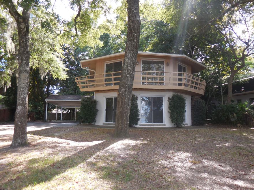 REO. WATERFRONT AND 6 BEDROOMS! WOW! Enjoy spectacular views of your personal waterfront property across the street from the unique ''hexagonal'' living room. Upstairs the ''hexagonal'' master bedroom commands even better waterfront views through its wall-to-wall patio doors which lead out onto the deck which spands the whole front of the home. The master bedroom also has its own private bath and 3 closets! Upstairs you will also find 3 other bedrooms and a full bath. Downstairs find a 2nd master suite and bath, bedroom 6 and bath #4! The waterfront views can also be enjoyed from the eat-in kitchen and formal dining room just off the living room! We've just painted inside and out, carpeted and vinyl floored, installed new appliances, had the HVAC serviced, and had a clear WDO!