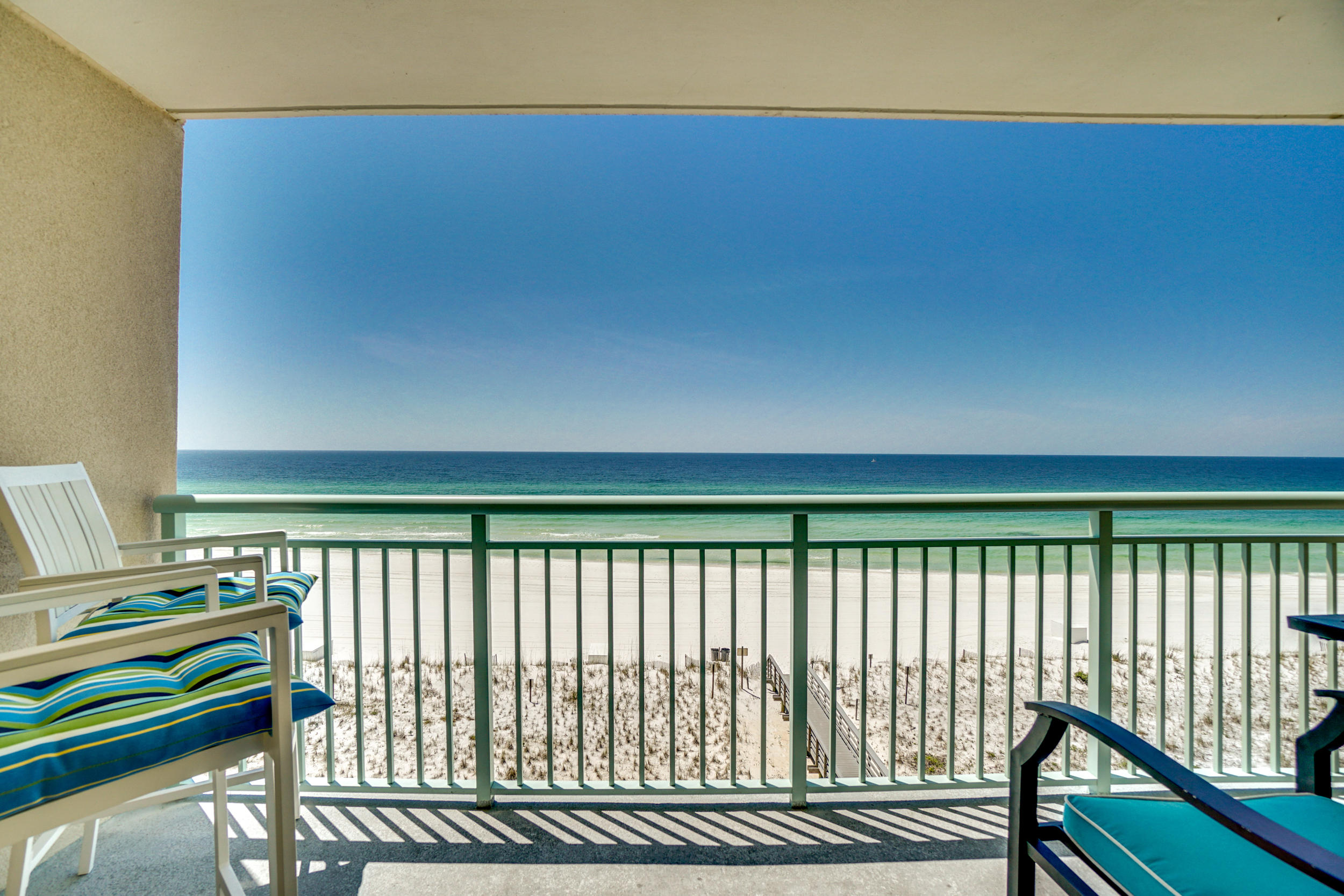 UNDER CONTRACT ACCEPTING BACK UP OFFERS These amazing wrap around lanais and coveted parking spot are not to be missed! Gulf views from this 2BR/2BA, 1,356SF end unit at Pelican Isle. This condo is bright and beachy with additional windows, new laminate wood flooring in the bedrooms, a relaxing large wrap-around balcony and an additional balcony off of the bedrooms. The kitchen features tile floors, a desk area, plenty of cabinet & counter top space, and a breakfast bar. The kitchen opens to the living space which has beautiful views and two access points to the wrap-around balcony. There are two nice sized bedrooms, one with a private bath and one with access to the hallway bath. Other features include hallway bunks, washer/dryer, and a deeded parking