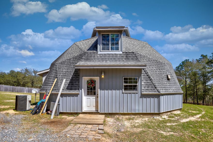 Custom built in 2011, this 3 bedroom 2 & 1/2 bathroom 2500 square foot dome design home is perched on a soft sloping hillside with wonderful scenery and abundant wildlife activity. Its gated-driveway and wooded surroundings offer privacy and serenity. The home was engineered and constructed to withstand 285 mph winds. Spray foam insulation was used to to lower electricity bills and increase the home's strength. This home will let you enjoy the country feel, but still be close to Crestview or Pensacola with a nearby access to Interstate 10. Also convenient to the beaches. The property also features a workshop with concrete floor. Seller to replace roof with contract. *SELLER IS VERY MOTIVATED*