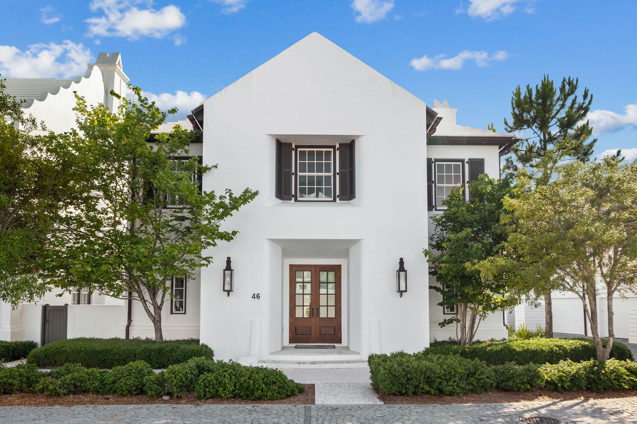 Erected in 2015 with the finest materials and fortified masonry structure, this Alys Beach residence evokes grandeur and architecture reminiscent of the Greek Islands while remaining geographically poised in one of the most exclusive and sought-after communities along 30A. Designed by the acclaimed team at T.S. Adams and executed by Alys Beach Construction, this Somerset Home encompasses over 3,400 square feet of expertly planned living space spanning two distinct levels seamlessly interconnected by a full-service elevator.Approached by the handlaid cobble-stoned road and gas-lantern lit entry, the residence is situated on a prime corner homesite offering heightened privacy with a true detached footprint.